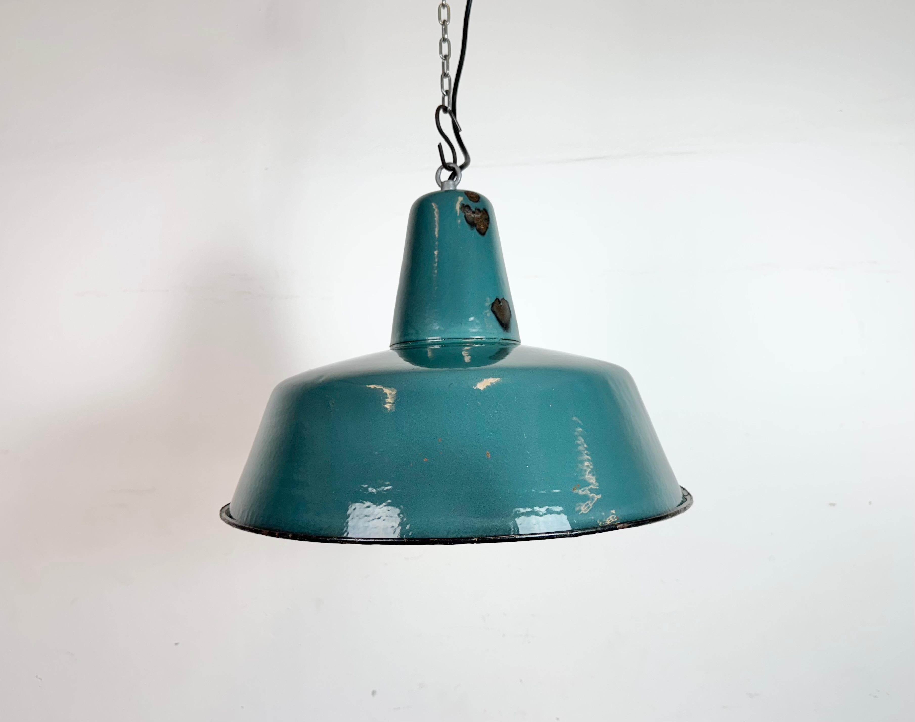 Industrial green ( petrol ) enamel pendant light made in Poland during the 1960s. White enamel inside the shade. Iron top. The socket requires standard E27/ E26 light bulbs. New wire. The weight of the lamp is 2 kg.The diameter of the lamp is 41 cm.