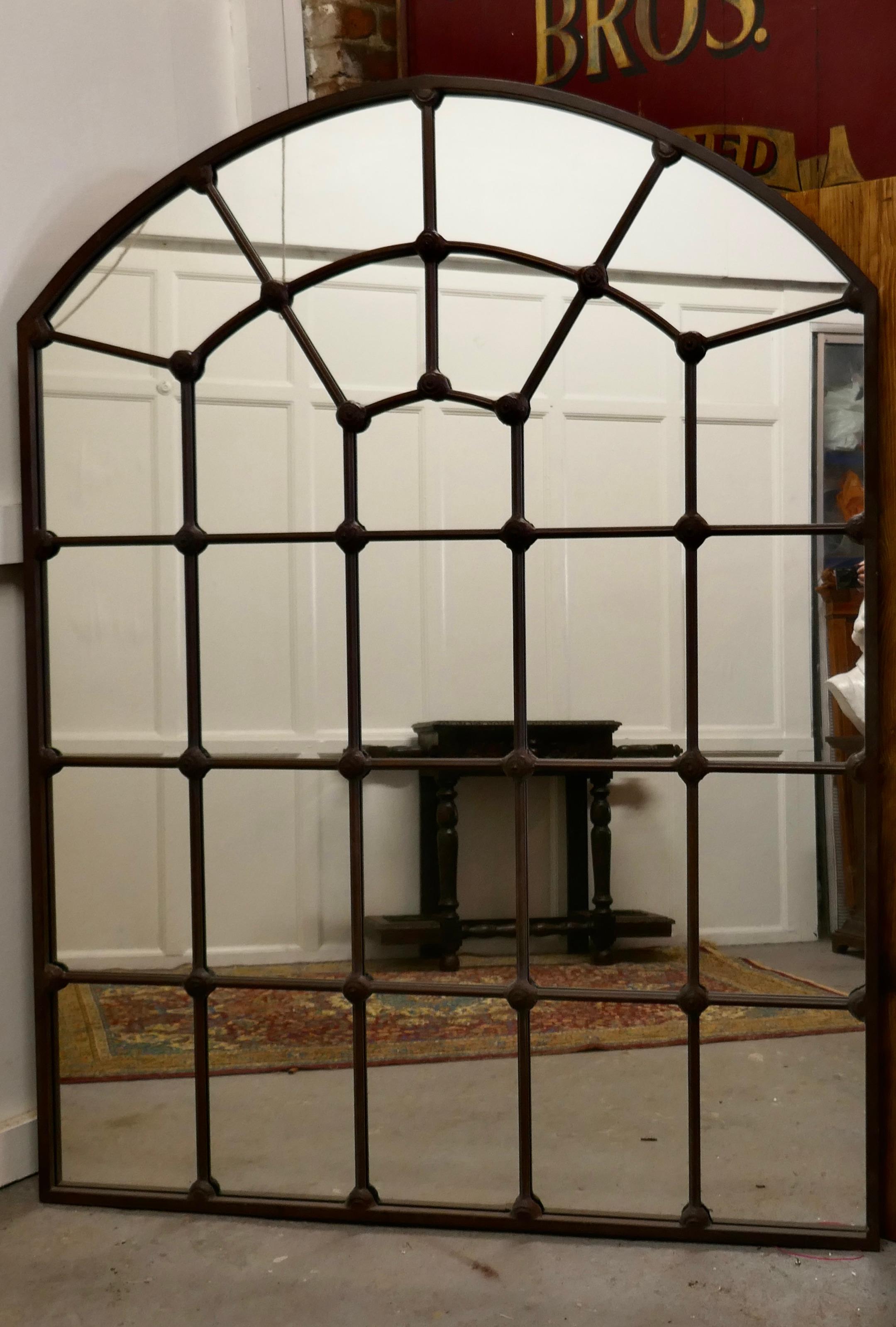 Large industrial style French window mirror 

This is a large and very attractive stand alone, the Iron Window Frame Mirror is divided into many pains with an arched top 
A truly stunning piece made in Iron which has a brown coating making it