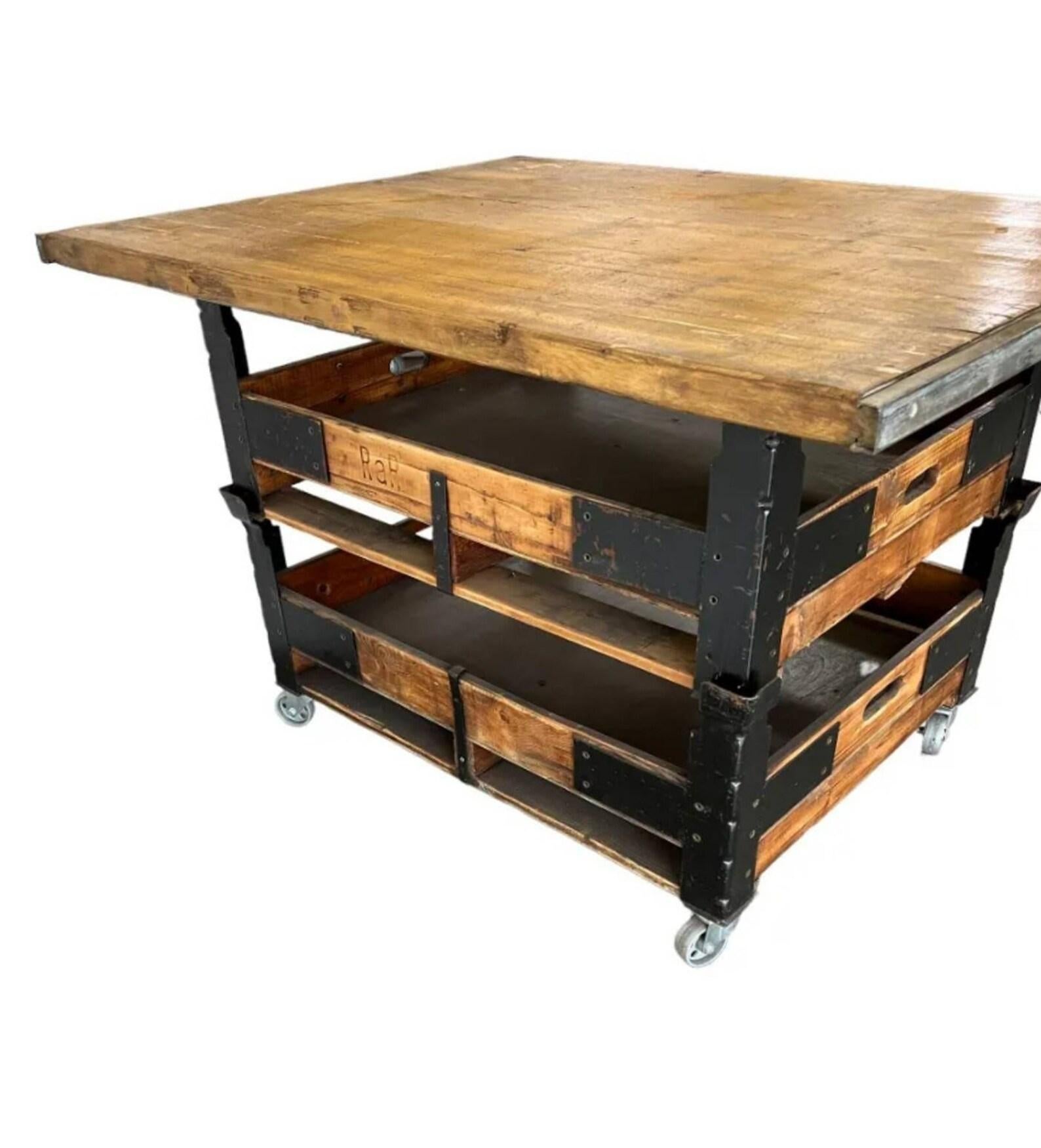 A large industrial rustic modern tiered workbench cart / kitchen island.

Crafted of earlier reclaimed antique elements, having a thick solid wood slab top with nicely aged patina and steel rail sides, over black metal frame with two wooden tray