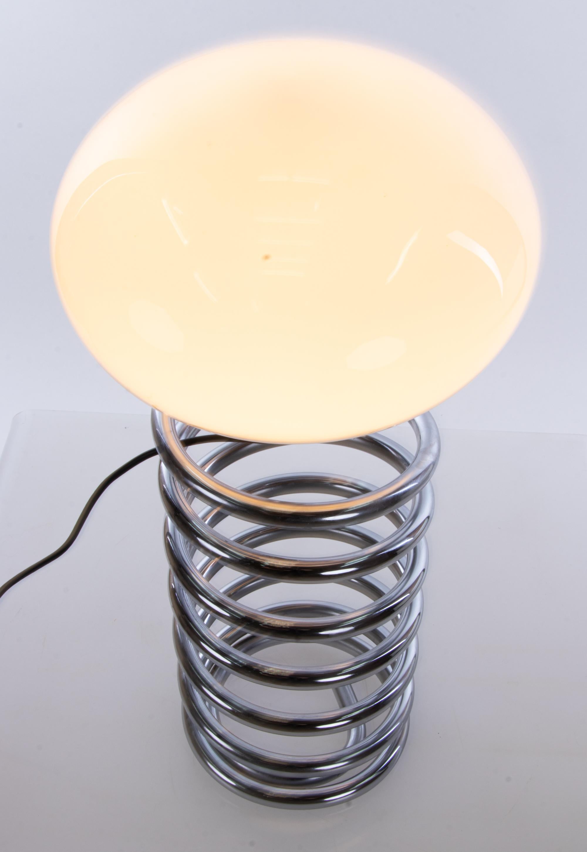 Large design desk light with a white glass shade on a chromed spiral steel base. Designed 1965 by Ingo Maurer for Design M, Germany. 

Design: Ingo Maurer. 
Model: Spiral, Spirale. 
Manufacturer: Design M. 
Measures: height 23.6