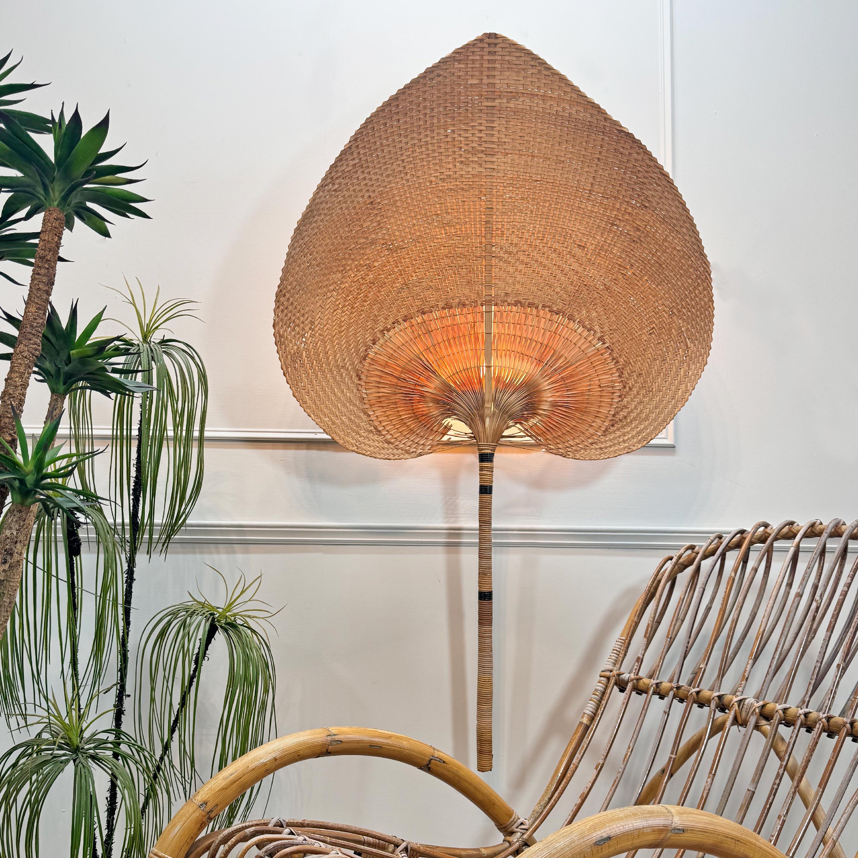 An impressive and very large scale Uchiwa (fan) wall light, very much in the manner of Ingo Maurer (this is not an Ingo Maurer Uchiwa), the huge fan constructed of split bamboo and woven grass, with a single e14 (small screw in) gold edison lamp