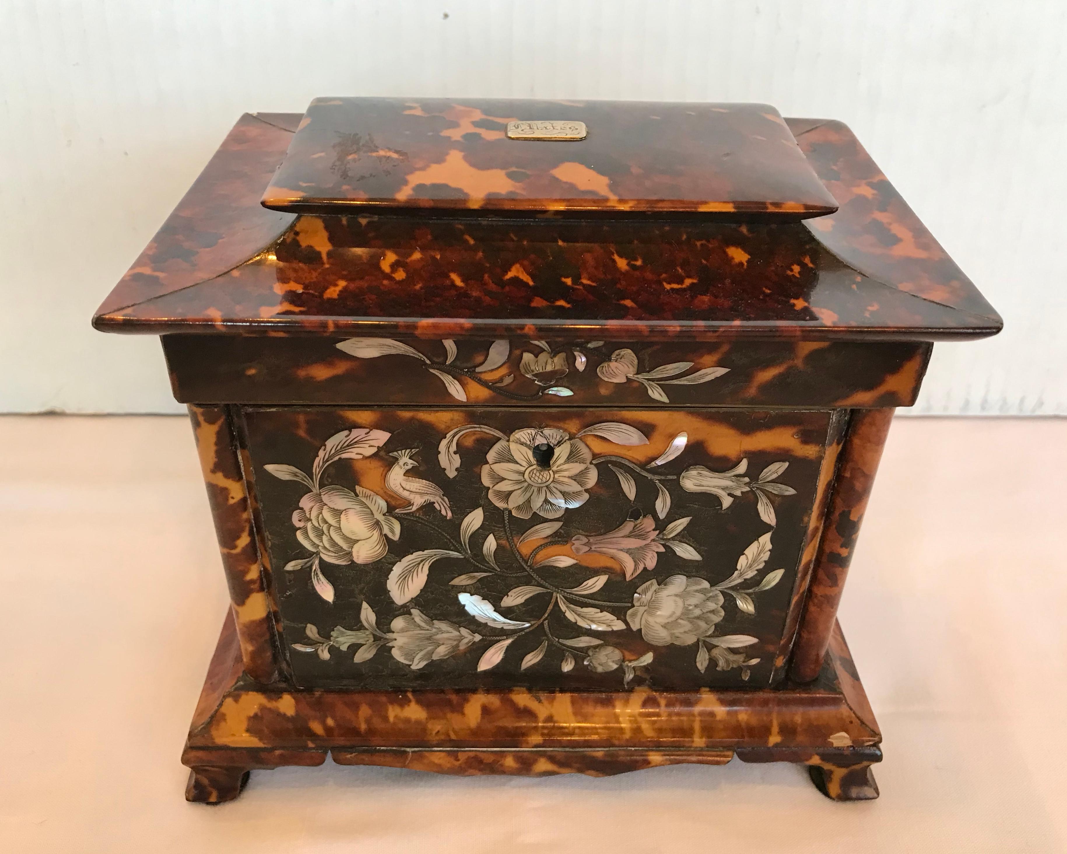 Absolutely fabulous! A stately caddy with fine mother of pearl floral inlays accented with a
Bird of paradise. Quite an unusual form and scale. The caddy is raised upon bracket feet
And is fashioned with columns on each side of its front and back.