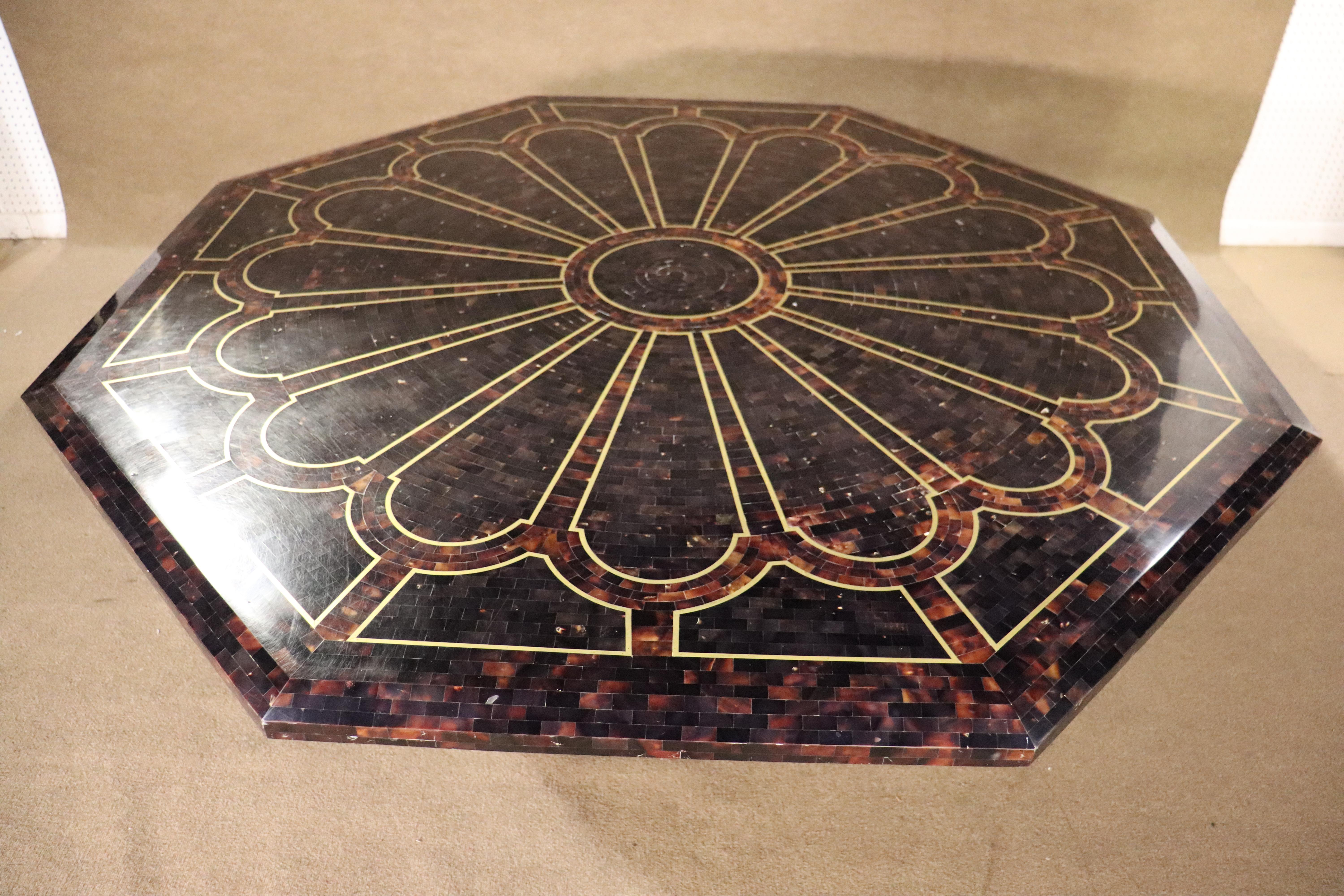 Large octagonal dining table in tessellated stone with brass inlay design. A stunning center piece for your dining room. This pedestal table is over five feet wide with designs on top and base.
Please confirm location NY or NJ