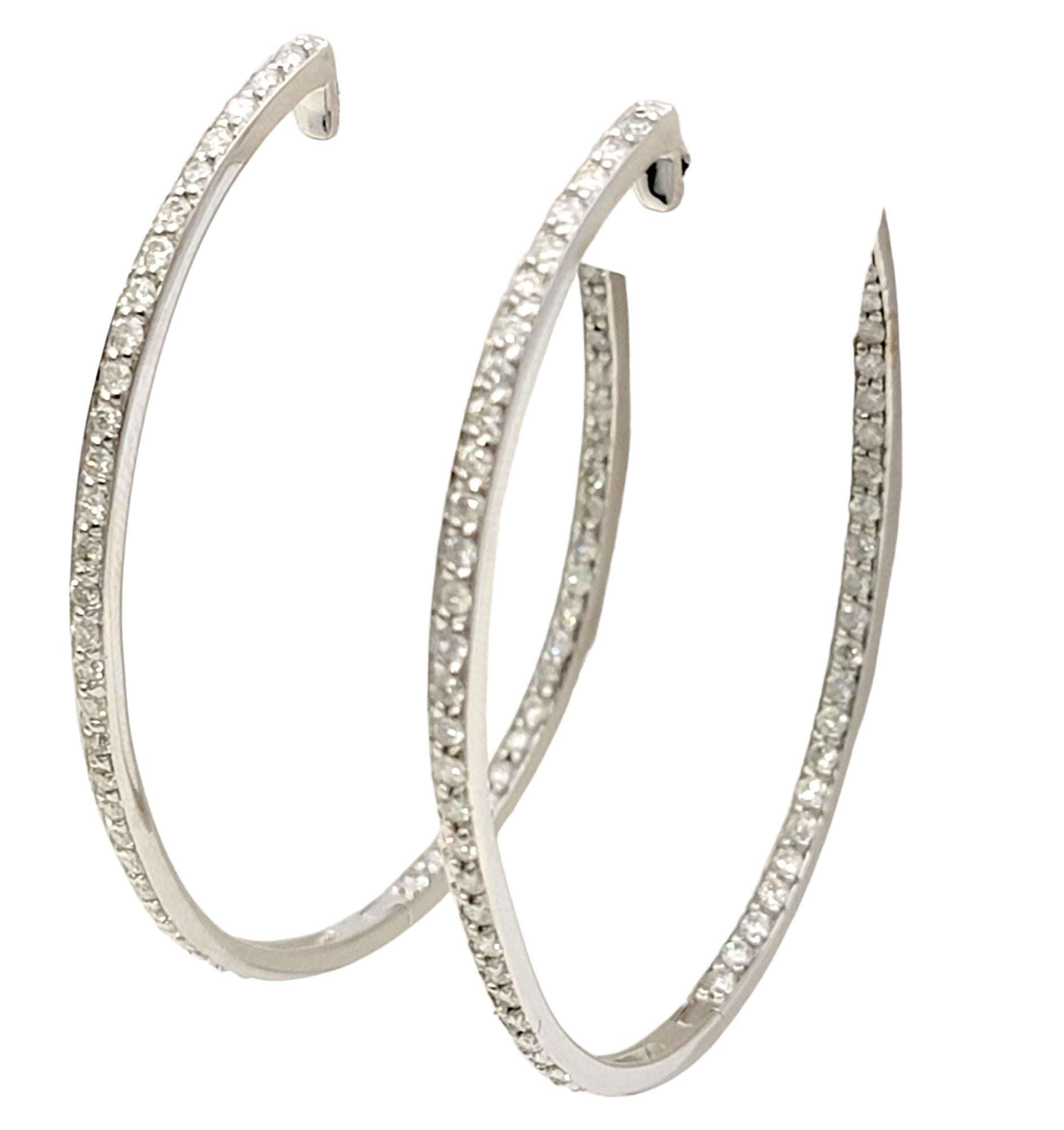 Indulge in the elegance of these stunning oval shaped inside-outside diamond hoop earrings. Crafted with exquisite attention to detail, these earrings are a true testament to timeless beauty. Each elongated hoop is meticulously adorned with dazzling