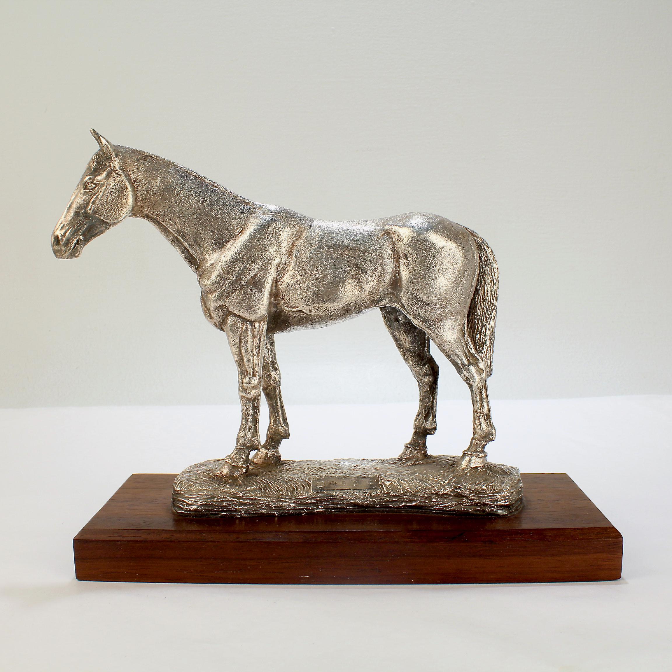 A fine, large Irish horse sculpture.

Modeled as a three-dimensional standing work horse on a wooden plinth. 

Comprised of cement-filled sterling silver.

Marked for the Camelot Silverware Ltd. company, a company known for their fine large-scale