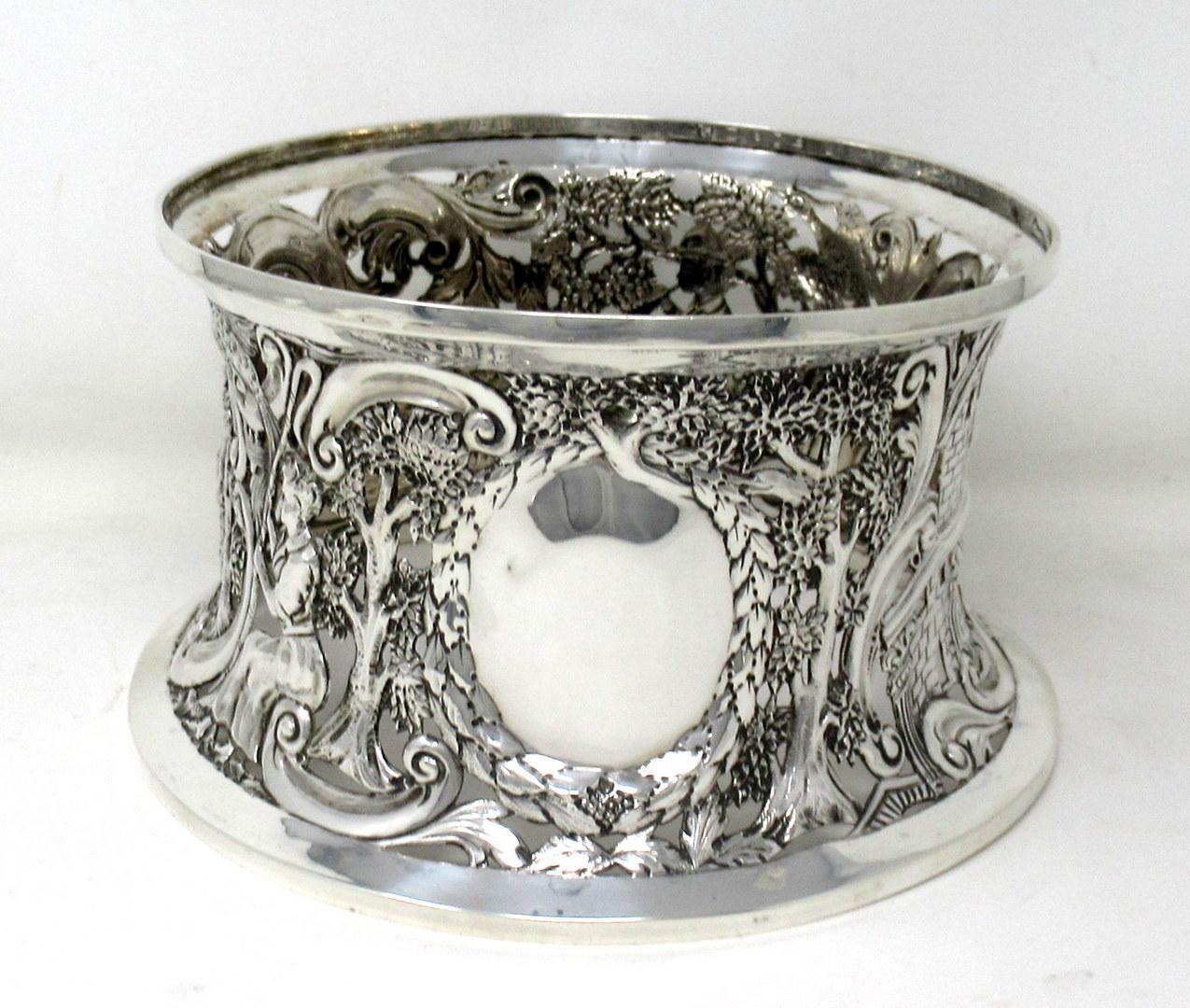 An Exquisite Irish Georgian Style Dublin Silver Heavy Gauge table dish ring of traditional waisted form in the Rococo manner, and unusually large size. 

The circular inverted sided lavish pierced body depicting a rustic scene with shepherdess, a