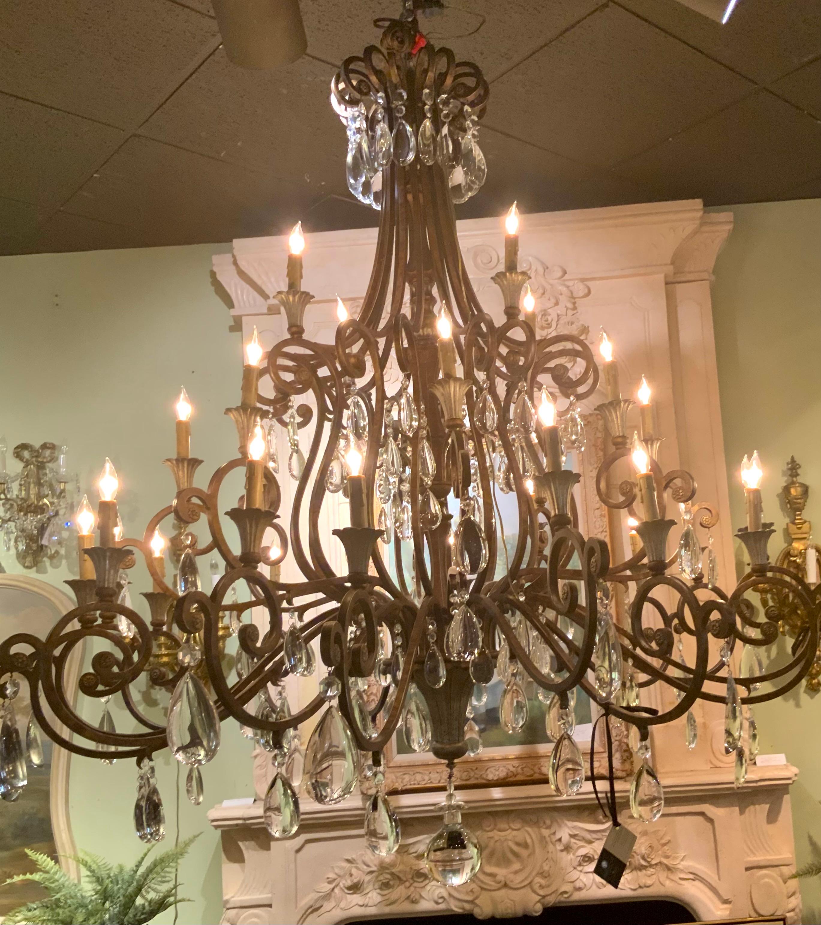 Large scrolling arms that are graceful with twenty nine lights illuminate this fixture. Silver highlights adorn the bottom
Portion of this chandelier and silver highlights also decorate
The cup portion of each light. It is large in scale and