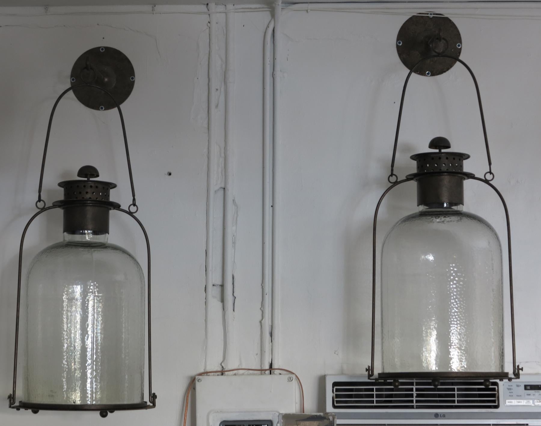 The glass globes lift up so a candle can be placed inside to make a great accent piece for your next soree.
These vintage lanterns could be electrified. One glass globe has a chip on the bottom edge that isn't visible when globe is in place.