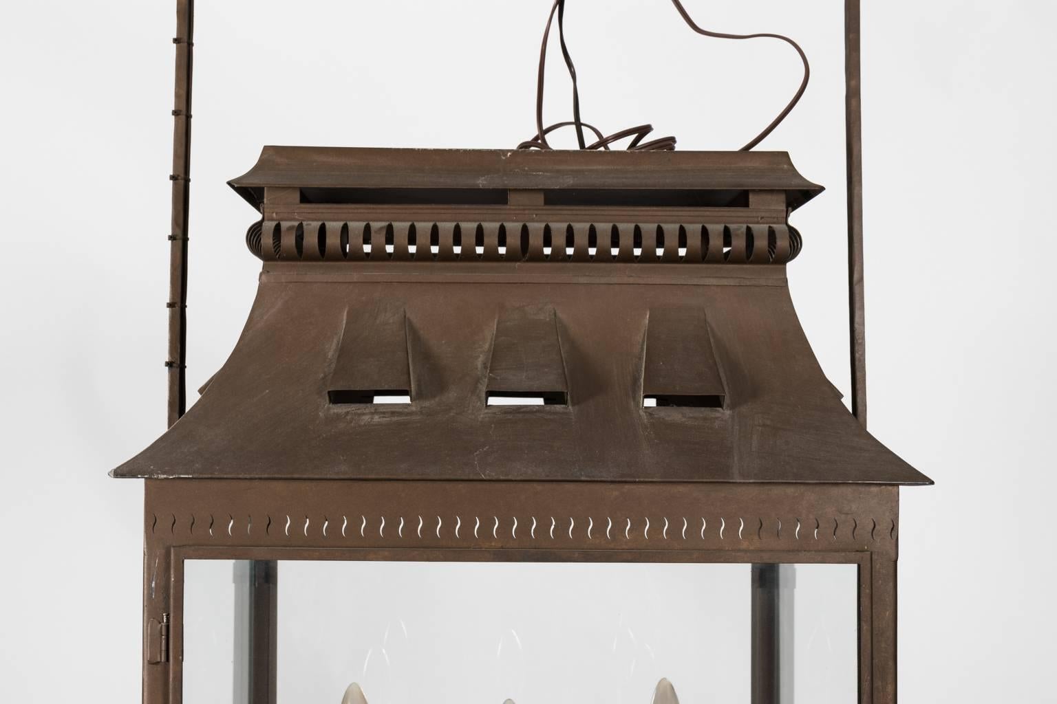 Late 20th century large iron exterior lantern with a cut out mansard roof and five lights.
 