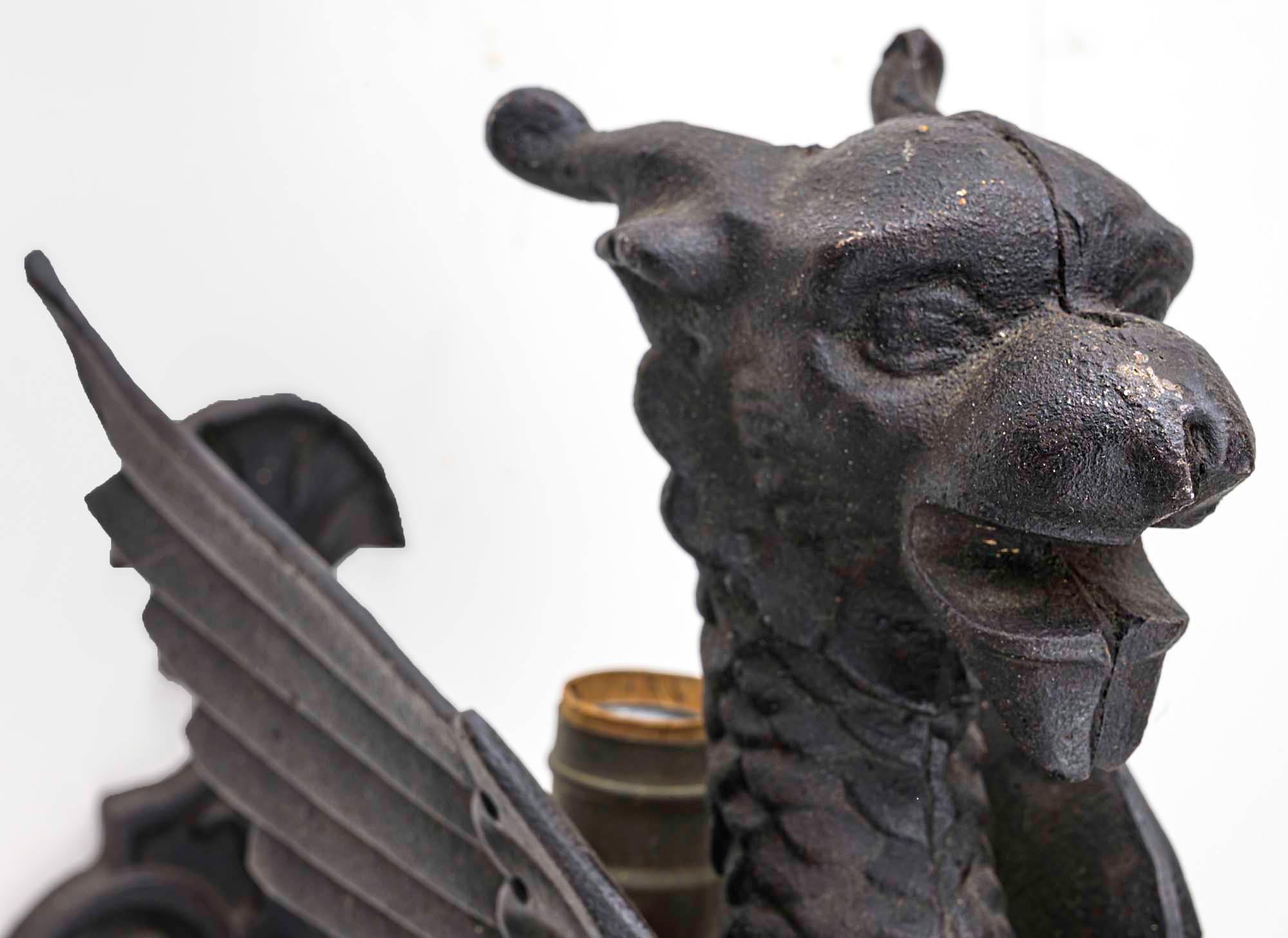 Large iron griffon wall sconce. Handsome winged lion, mythological creature cast in iron.
Very well detailed with fierce face to ward off evil spirits.
Electrified, light coming from between the two wings. About 22” high.