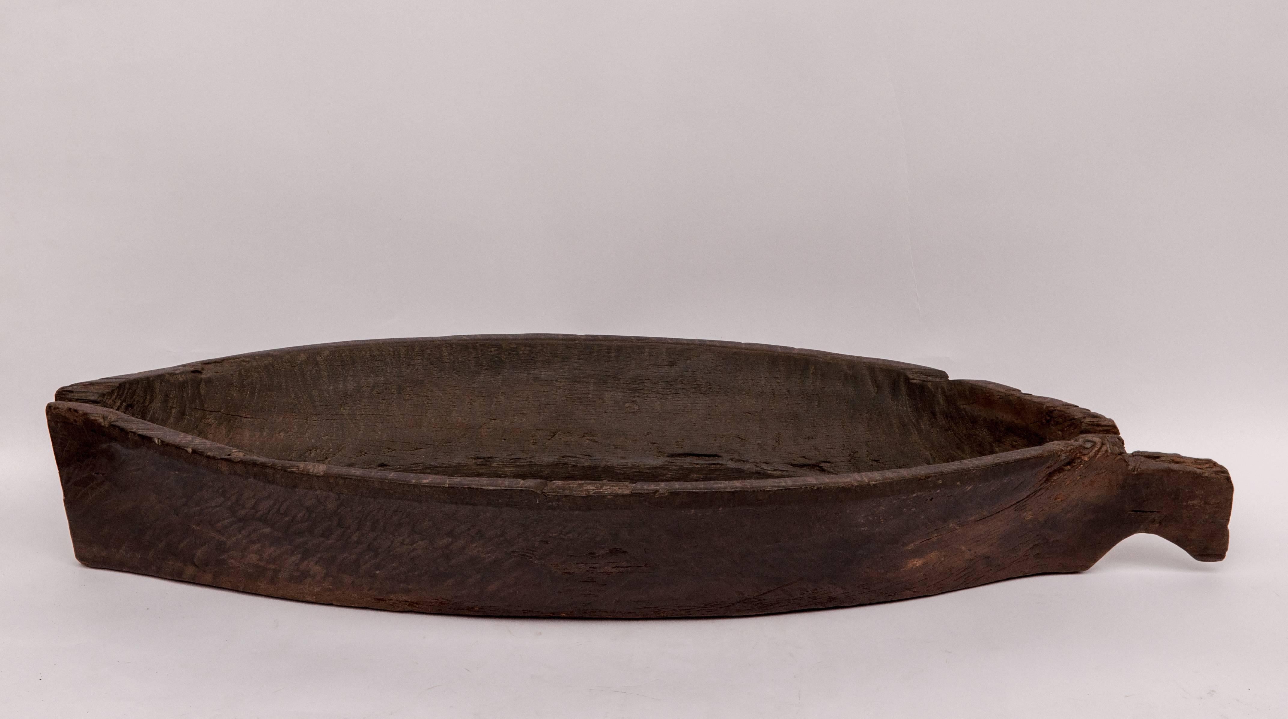 Large ironwood trough / tray from Borneo, mid-20th century.
Offered by Bruce Hughes.
This bowl is hand hewn from a single piece of very dense ironwood. There is some erosion near the handle as well as at the other end of the piece, but it is