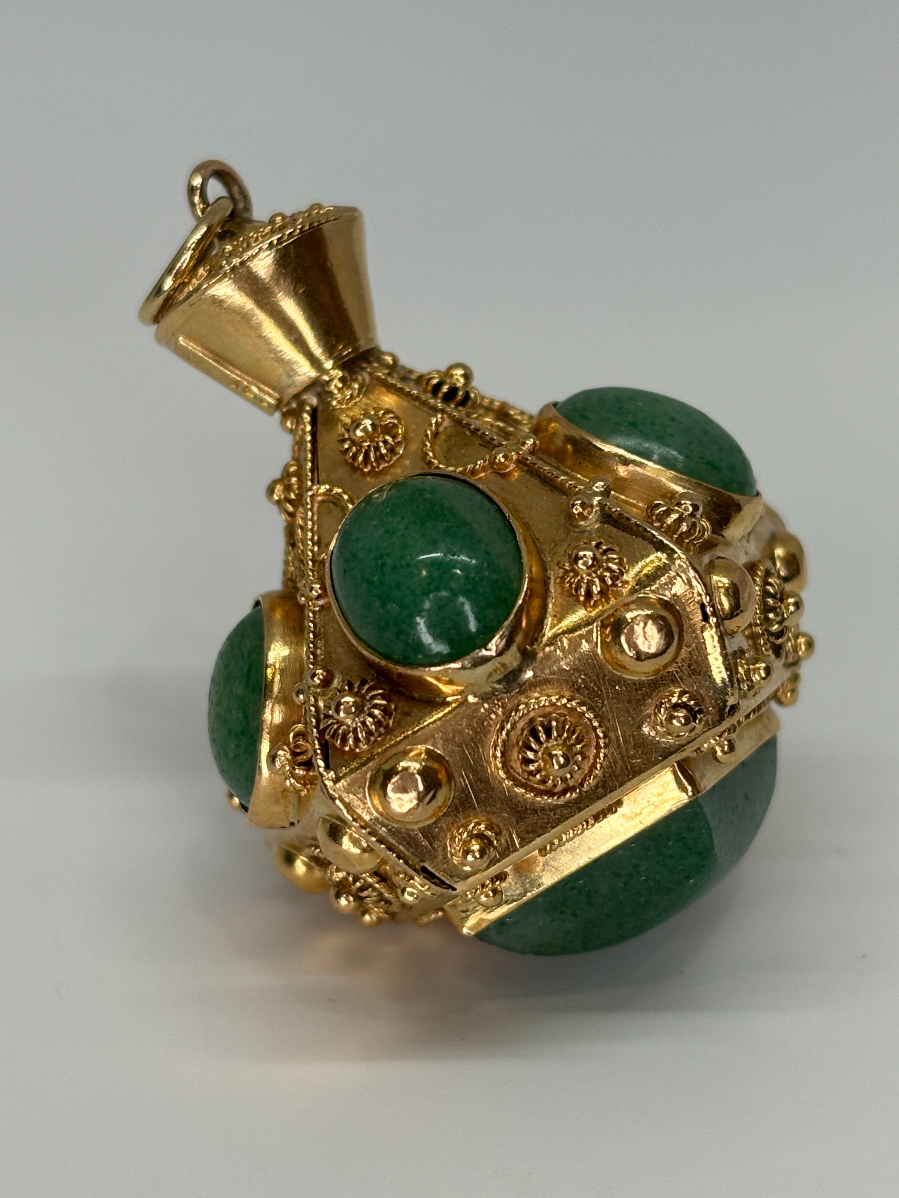 This vintage 18k gold Italian charm is encrusted  with vivid green aventurine set among Etruscan Revival wirework and granulation. The ornate vintage piece was most likely first purchased at the Ponte Vecchio, a bridge in Florence famous for its