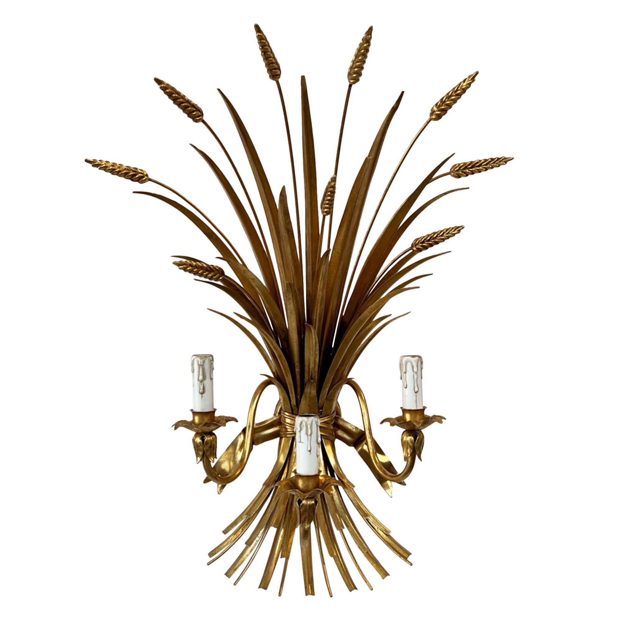 These large but intricately detailed wheat sheaf wall lights were made in Italy in the 1970s. They each have 3 lights held on strong curving arms. Crafted with expertise from gilt metal, all the leaves, ears of corn and rope ties are brilliantly