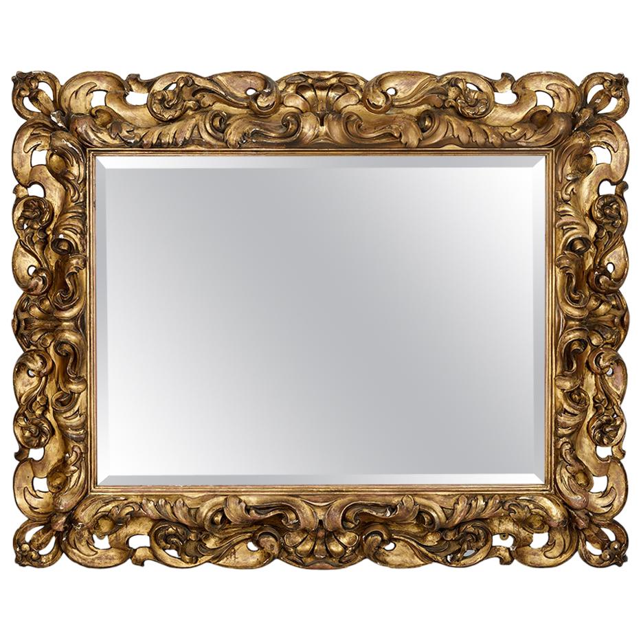 Grand miroir italien en bois doré sculpté du 19ème siècle