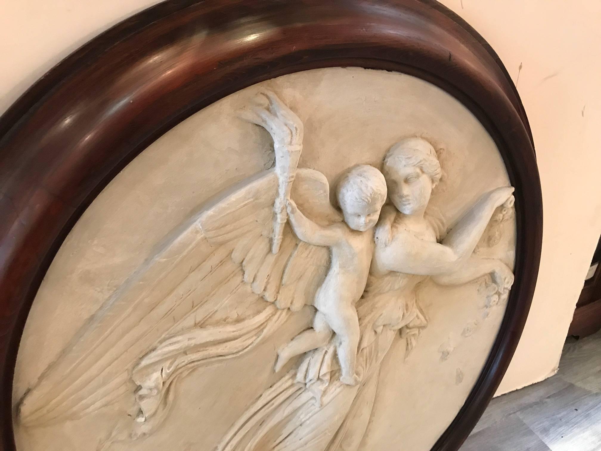 A large allegorical plaster high relief plaque of the Angel of Grace. This is a 19th century Grand Tour sculpture of an ancient original. The large plaque with mounted wood frame in a dense heavy solid plaster resembling the original in marble,