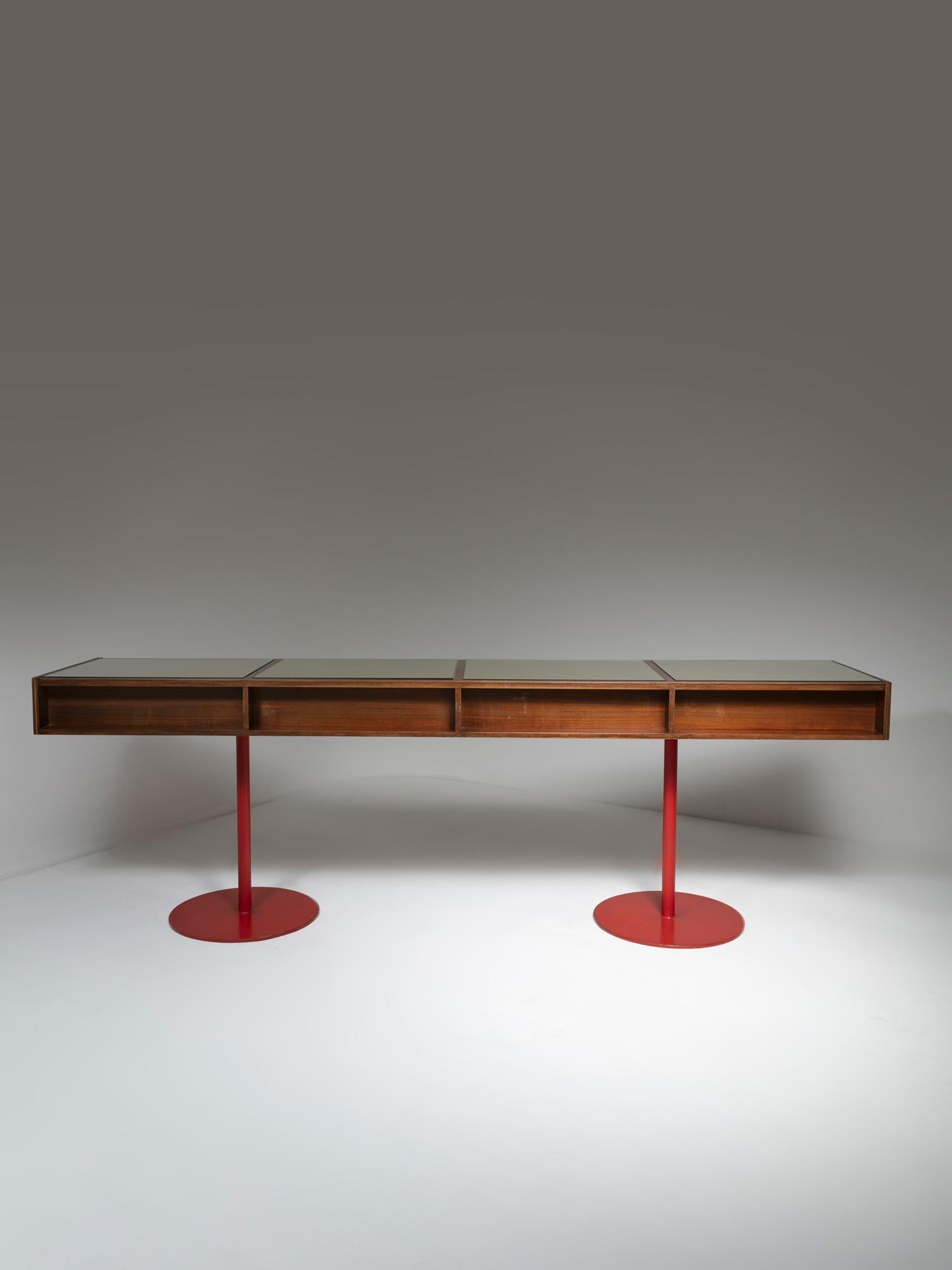 Generous wood counter with iron feet.
top is visually divided on four squared areas with glass top.
One side is equipped with several drawers.
The piece comes from a commercial area on a Carlo Scarpa building.