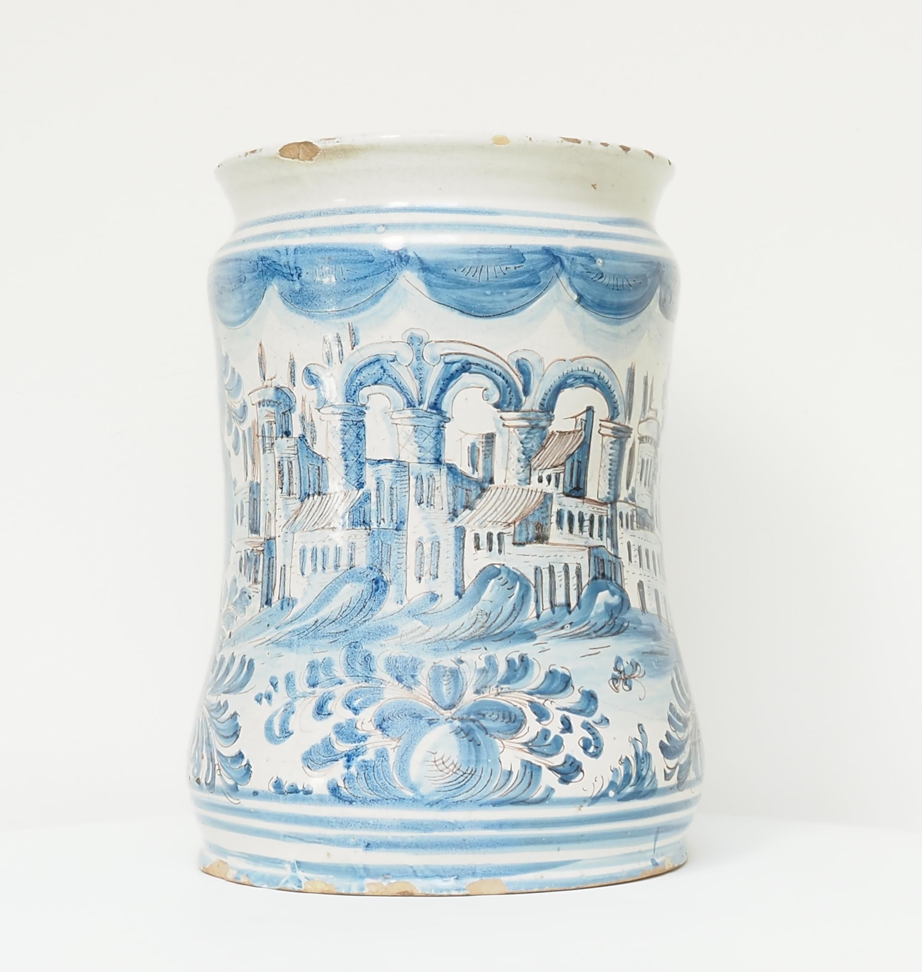 Large Italian Albarello, 18th Century

An impressive 18th-century Italian albarello, notable for its size and the finely painted continuous cityscape in cobalt and manganese tones. Originally intended for apothecary use, its elaborate decoration