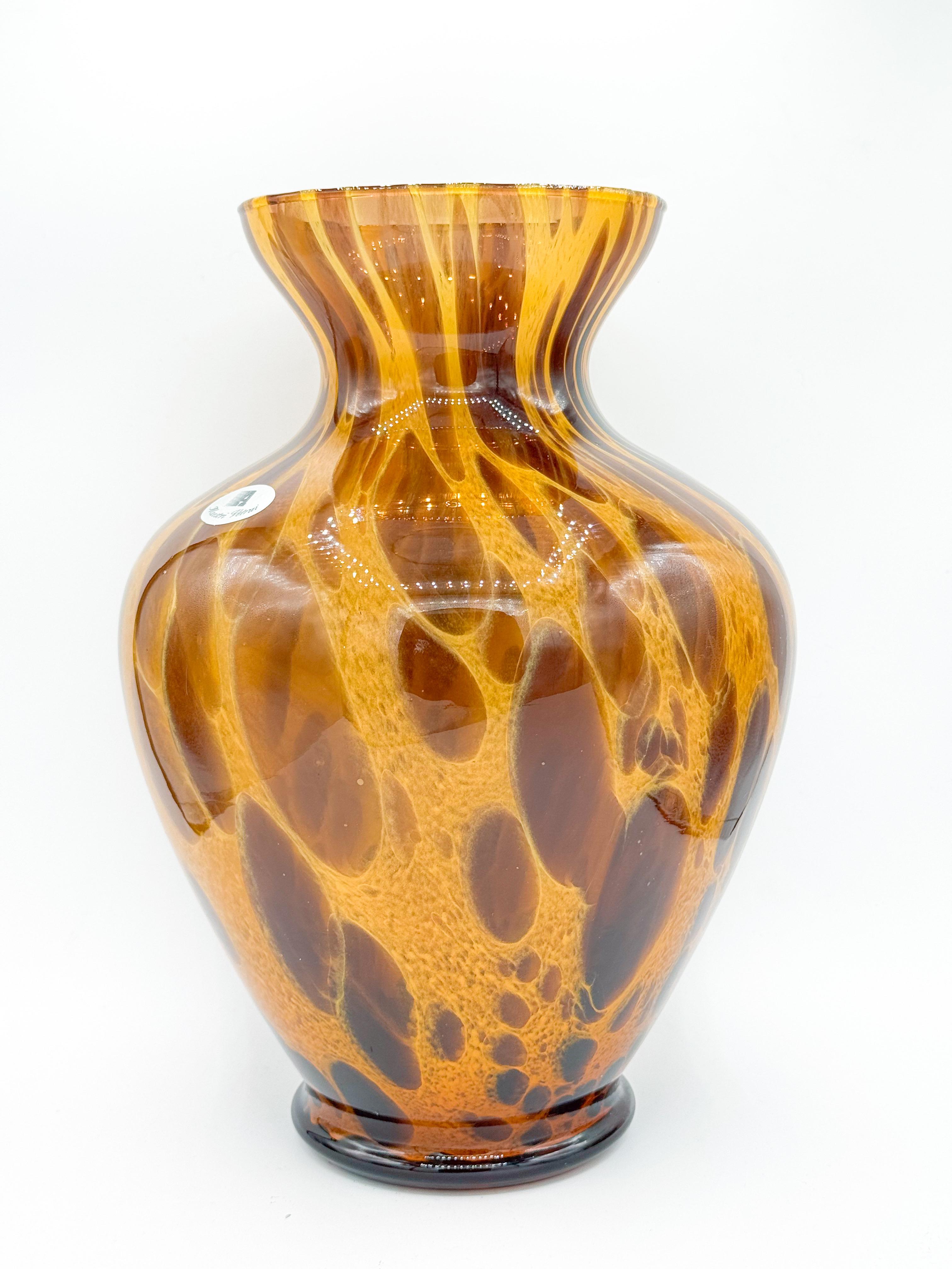 Striking and sculptural, this large Murano glass vase was handcrafted in Italy and marked Maestri Vetrai. Dating to the 1970s, it features a rich tortoiseshell pattern in deep amber and golden brown tones, with beautifully layered swirls that catch