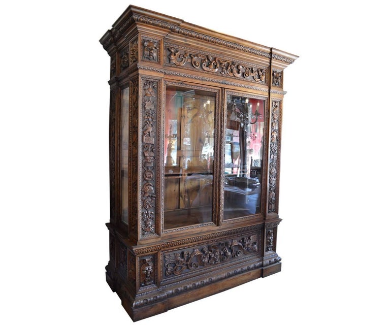This is a fantastic Renaissance Revival bookcase that is extremely deep and serves well as a display case also. It has original windows and carvings on the sides. The quality of carvings is extremely high with even the space between the subjects