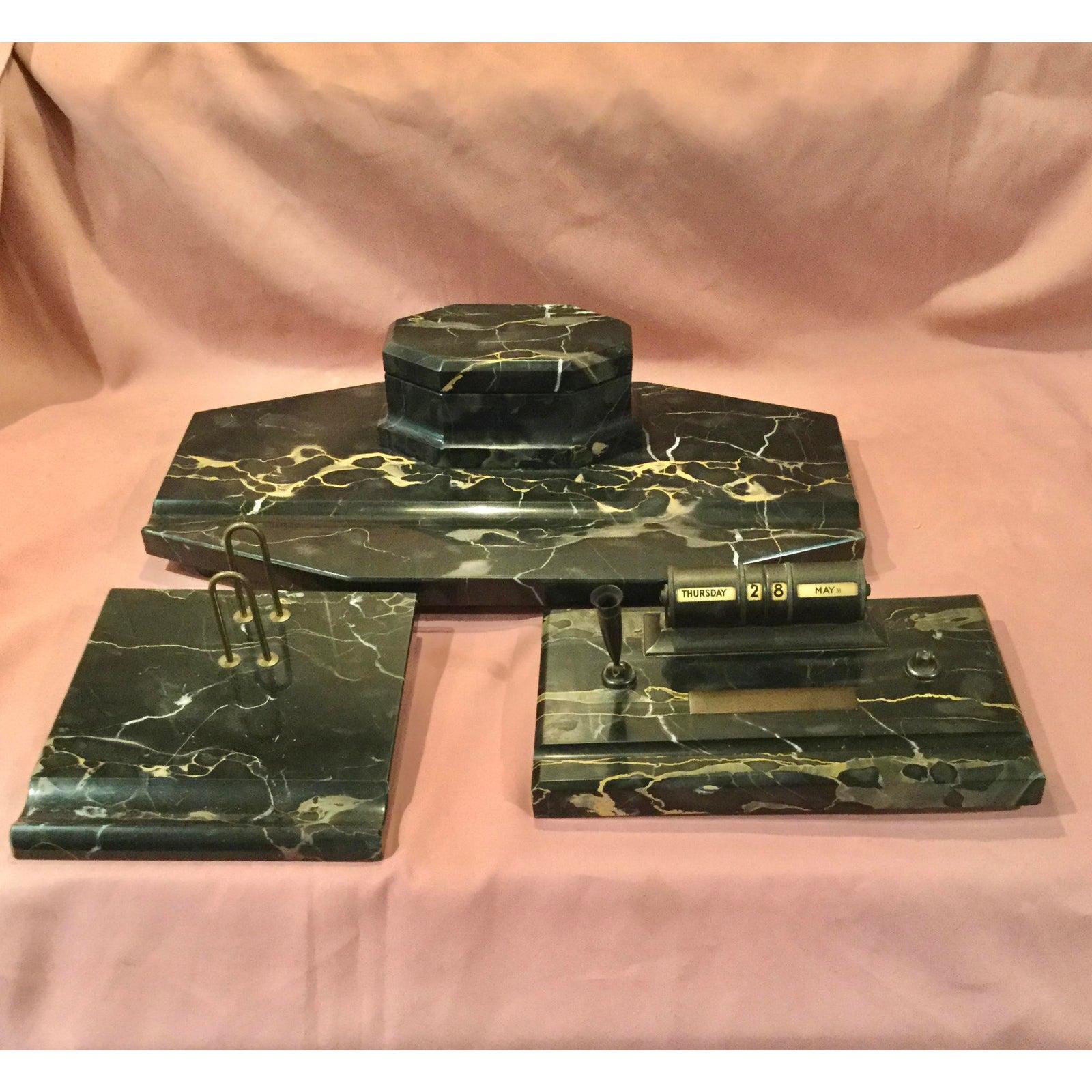 An outstanding large desk set made of the beautiful Portoro marble and brass from Italy. There are large pen trays and the glass inkwells that are original and perfect. Marble is black with a Carmel color running through it. Stamped Italy.
There is