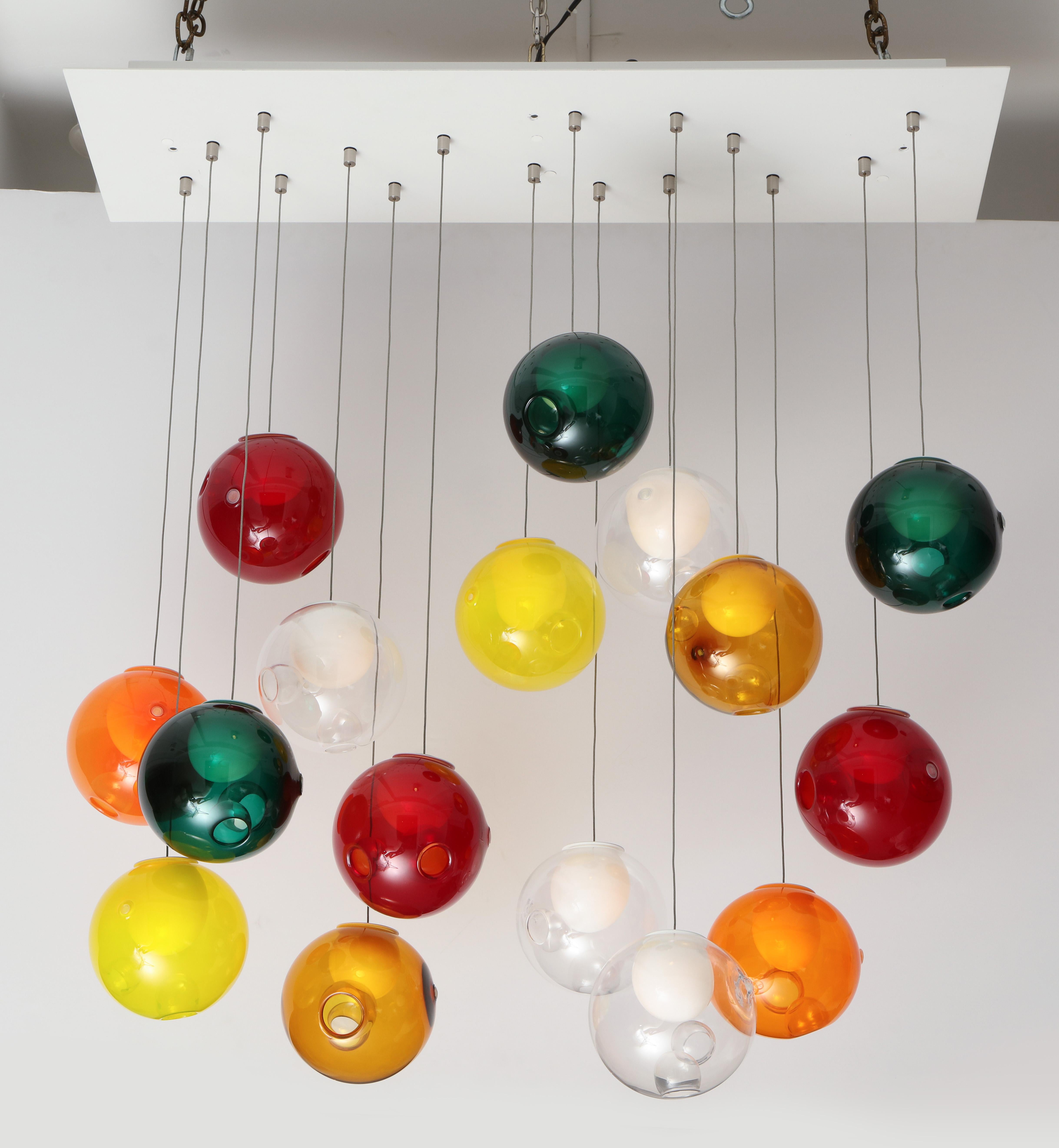 Wonderful Italian ball chandelier.
The large rectangle metal plate supports sixteen suspended handblown glass ball globes 
each with their own light source that when illuminated creates a Fabulously fun chandelier.