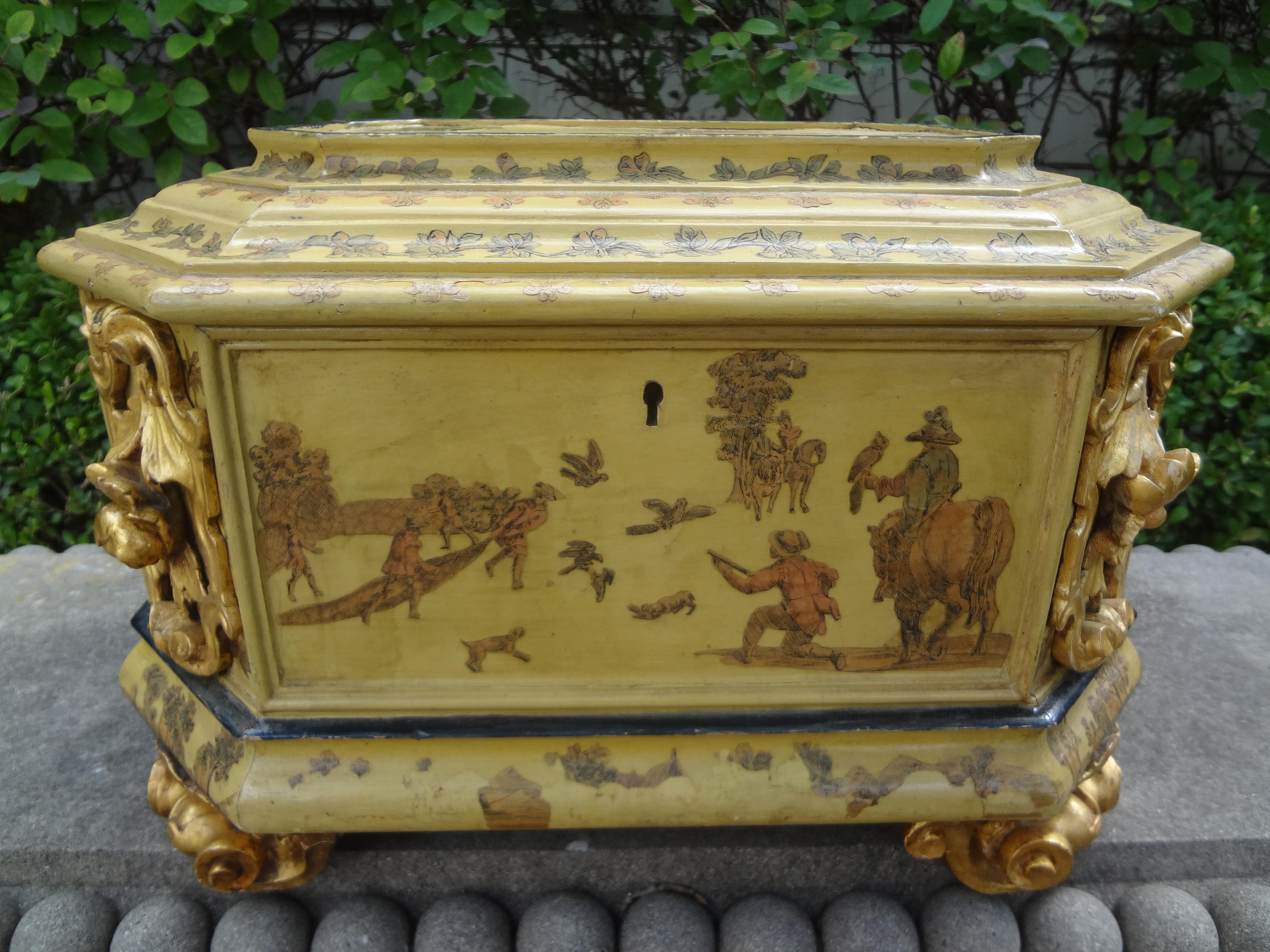 Stunning large scale Italian Baroque style carved wood box with graceful scrolled feet and lion head handles. Our antique Italian box was artistically decorated with pen and ink on all sides. This lovely hand decorated decorative box would make a