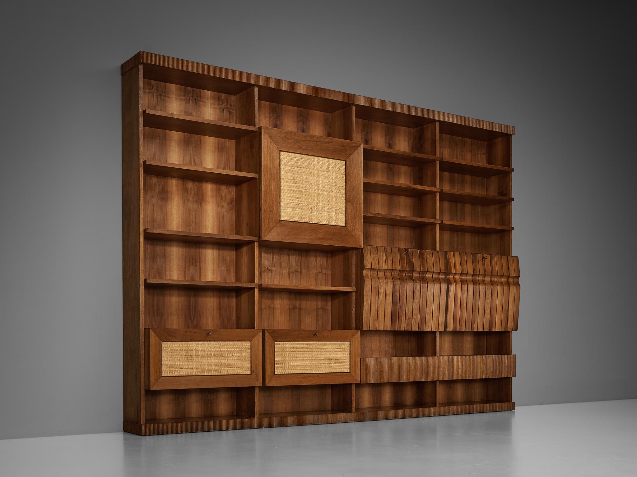 Library, walnut, cherry, grasscloth, Italy, 1950s

This delightful bookcase reflects the design principles of the Mid-Century era that rose to prominence in the 1950s and 1960s. The composition is based on four identically sized columns, each