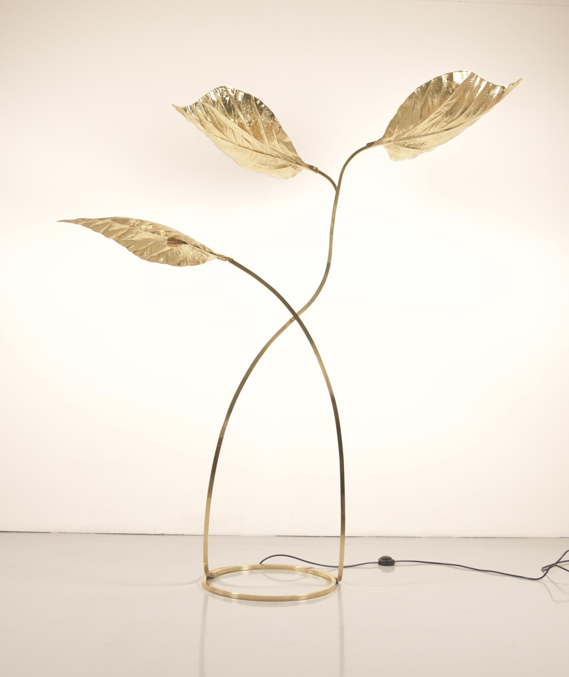 Large brass floor lamp by Tommaso Barbi. Brass floor lamp with three large rhubarb leaf style that light up.