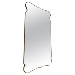 Large Italian brass framed mirror in the style of Gio Ponti .