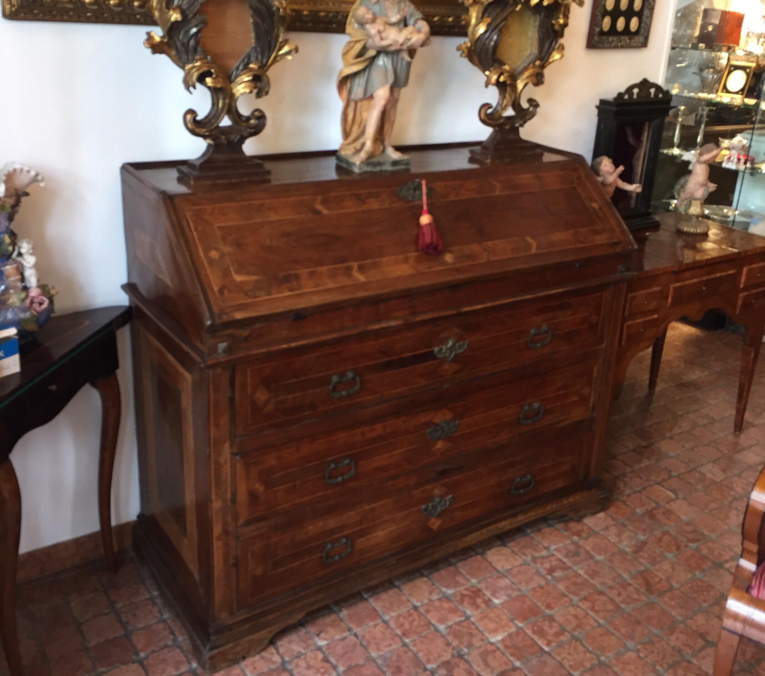 An Italian monumental sized bureau with flap dating back to the second half of 18th century. Three deep drawers and a fall-front opening to reveal a fitted interior with six small drawers and hiding secrets (see pictures below).
This antique bureau