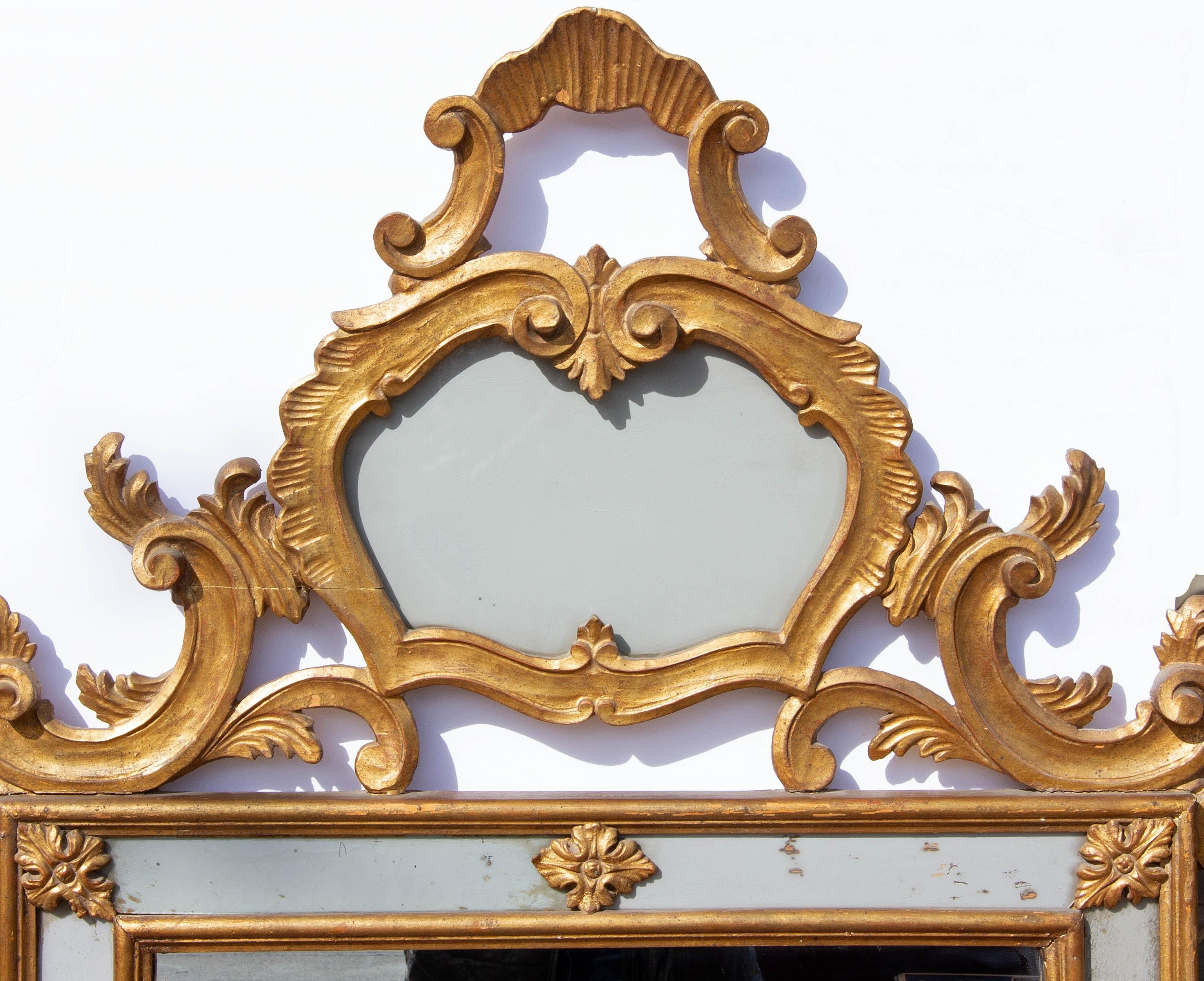 Large Italian gilt wall mirror. Mirror center panel with antiqued opaque side panels, Mid 20th century. Measures: 65