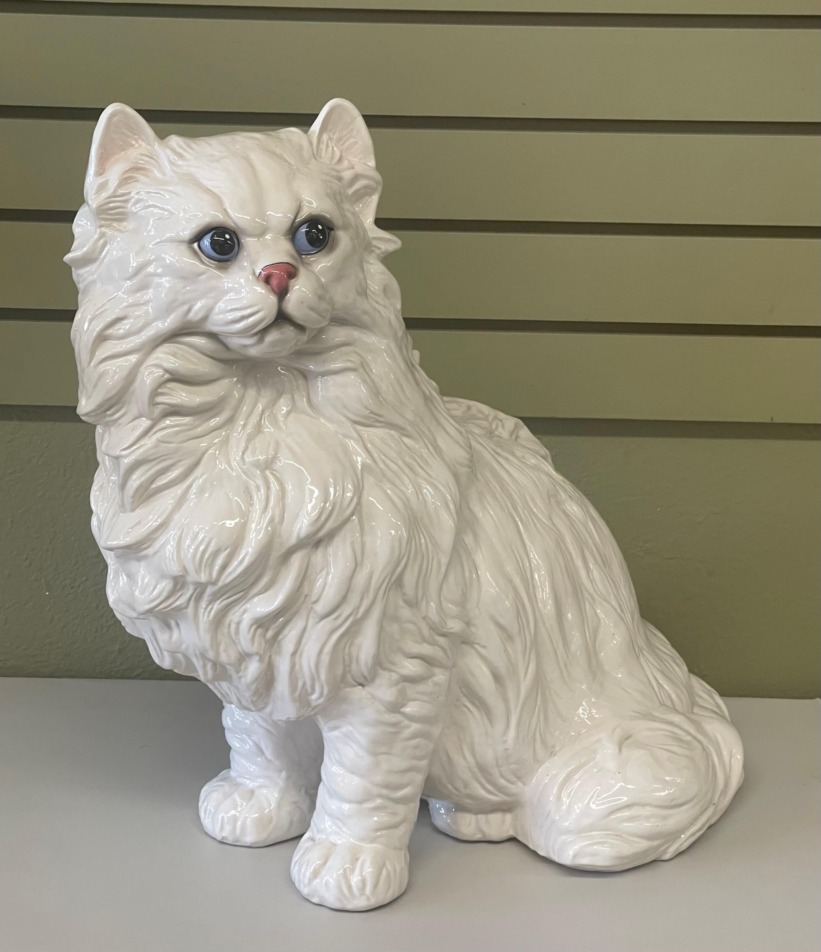 A very large Italian ceramic cat sculpture with sky blue eyes, circa 1970s. The piece is very well done with great detail; it is in very good vintage condition with no chips or cracks and measures 20.5