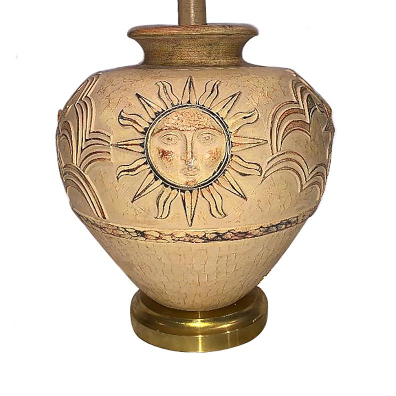 A large circa 1960s Italian dry-glazed ceramic table lamp depicting the sun on 4 sides with brass base.

Measurements:
Height of body: 17