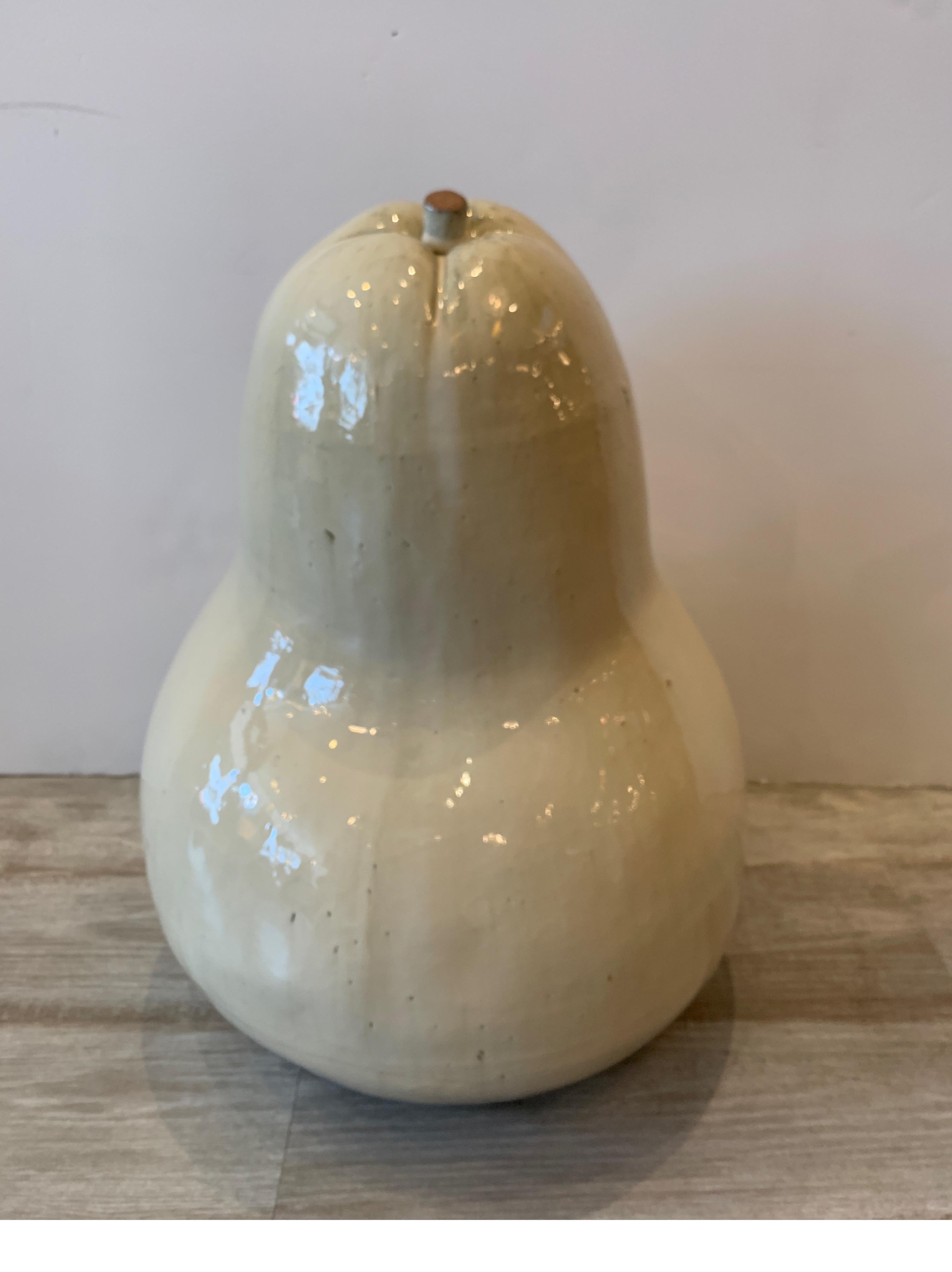 A tin glazed earthenware sculpture of a pear, marked on bottom, 