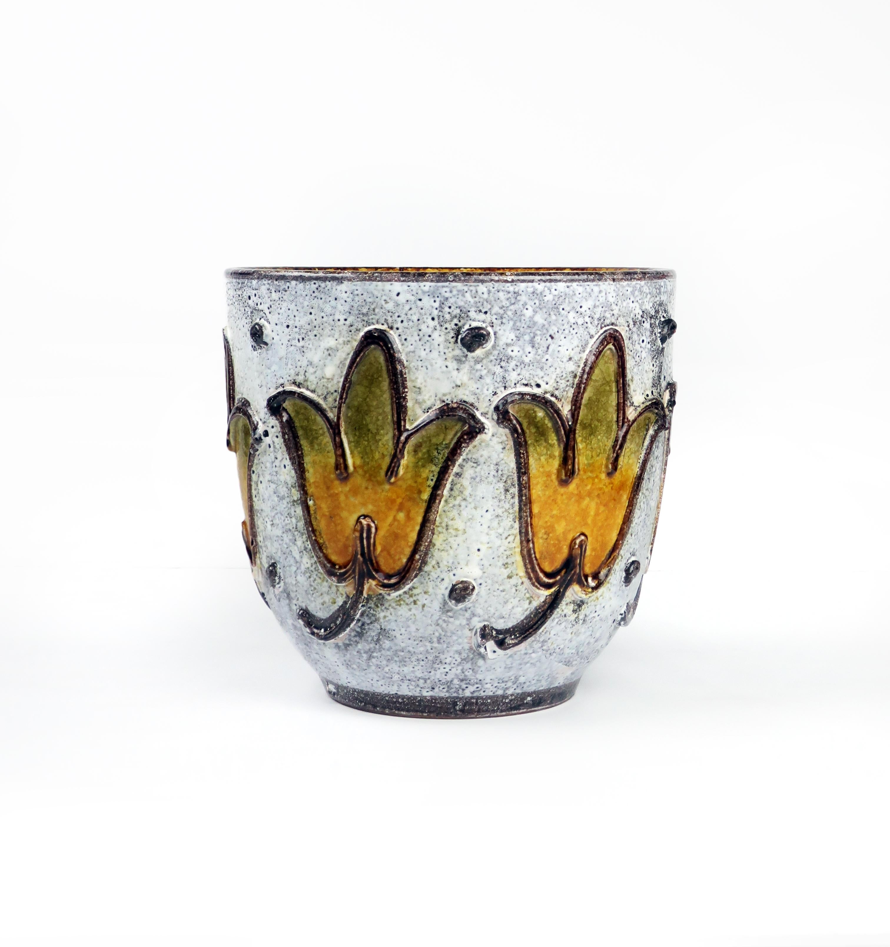 A large hand-painted ceramic planter in the style of Bitossi, Raymor, and Rosenthal Netter. White lava glaze over a dark base glaze with applied flowers and decorative elements. Beautifully hand painted with no signs of wear, use, or