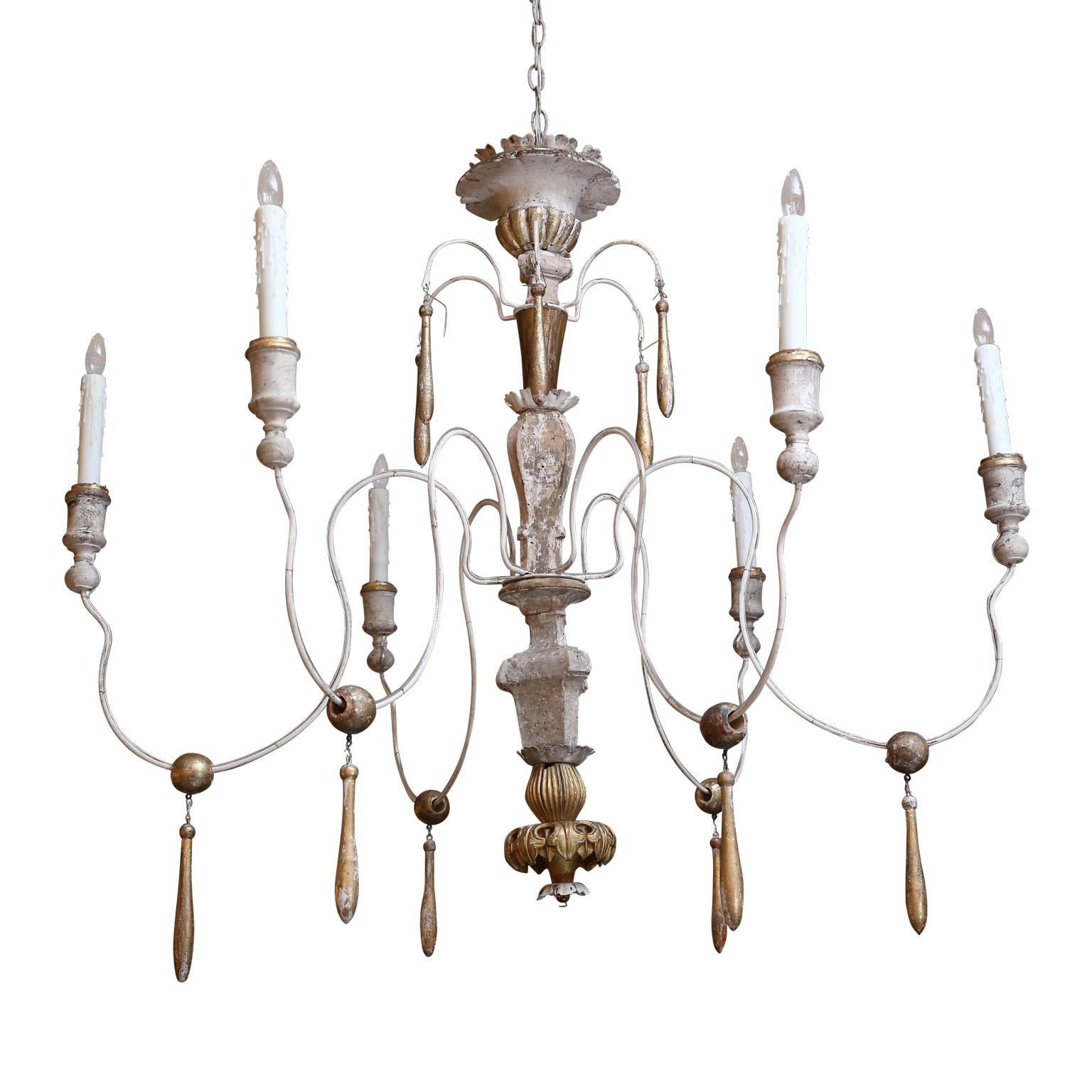 Large Italian chandelier from antique elements with six later iron arms. All wooden parts are hand carved 18th and 19th century fragments adorned with remnants of original gilt finish. Newly wired for use within the USA using all UL listed parts.