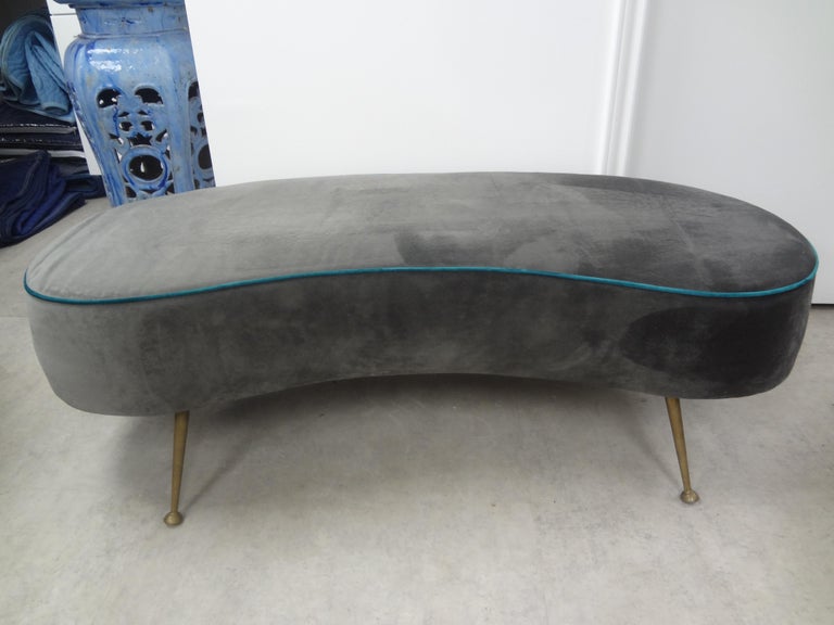 Large Italian curved bench with splayed brass legs by MarCo Zanuzo. This stunning Italian modern Gio Ponti inspired bench is upholstered in gray velvet with turquoise piping. Easy to re-upholster in the fabric of your choice. Perfect floating in a