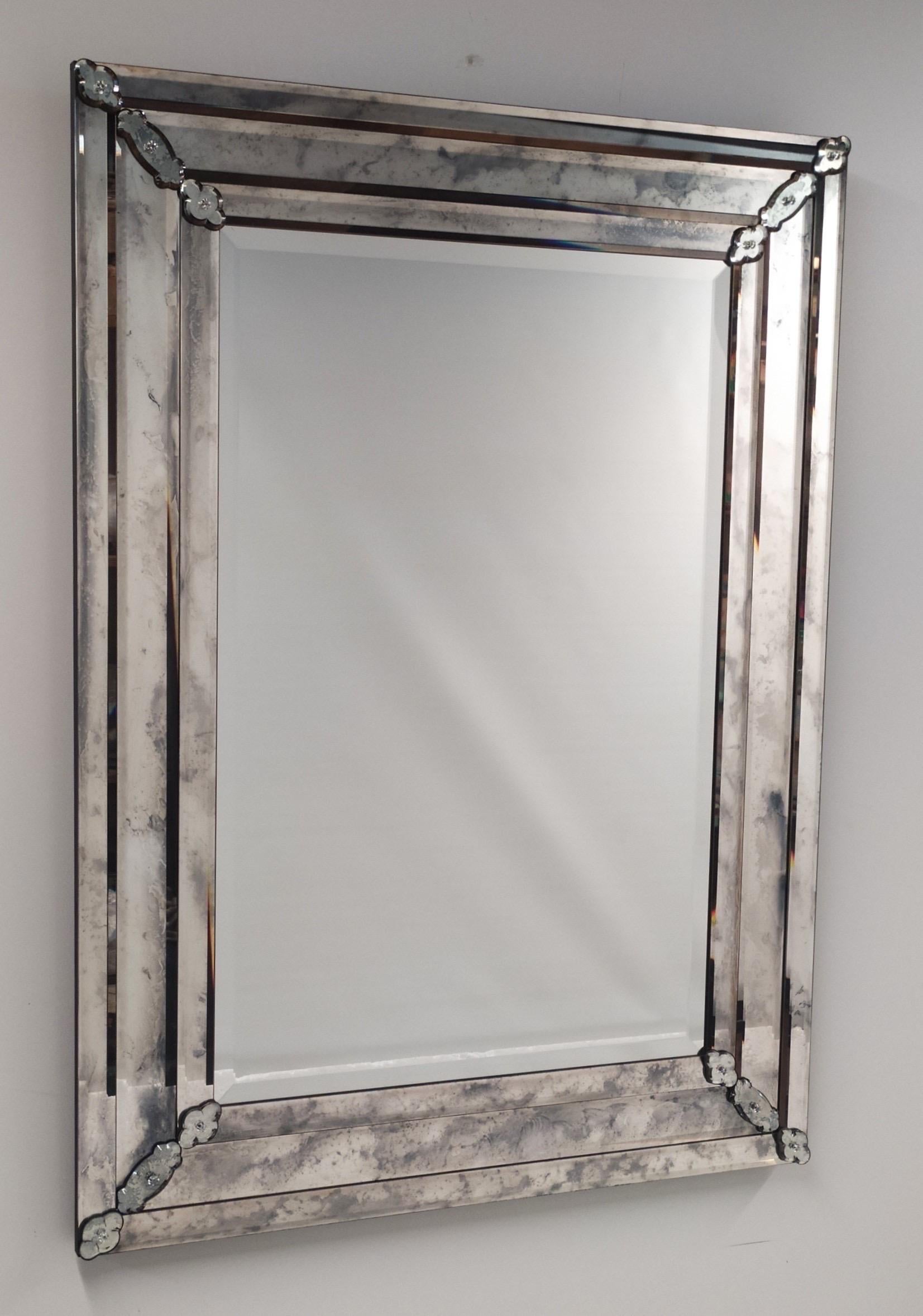 Large, Elegant, Custom Italian 18th Century Style antiqued and bevelled Venetian / Murano glass mirrors by Fratelli Tosi in the Modern Neoclassical spirit. The mirrors have a pure and sober styling with minimal decoration and reflect the style of