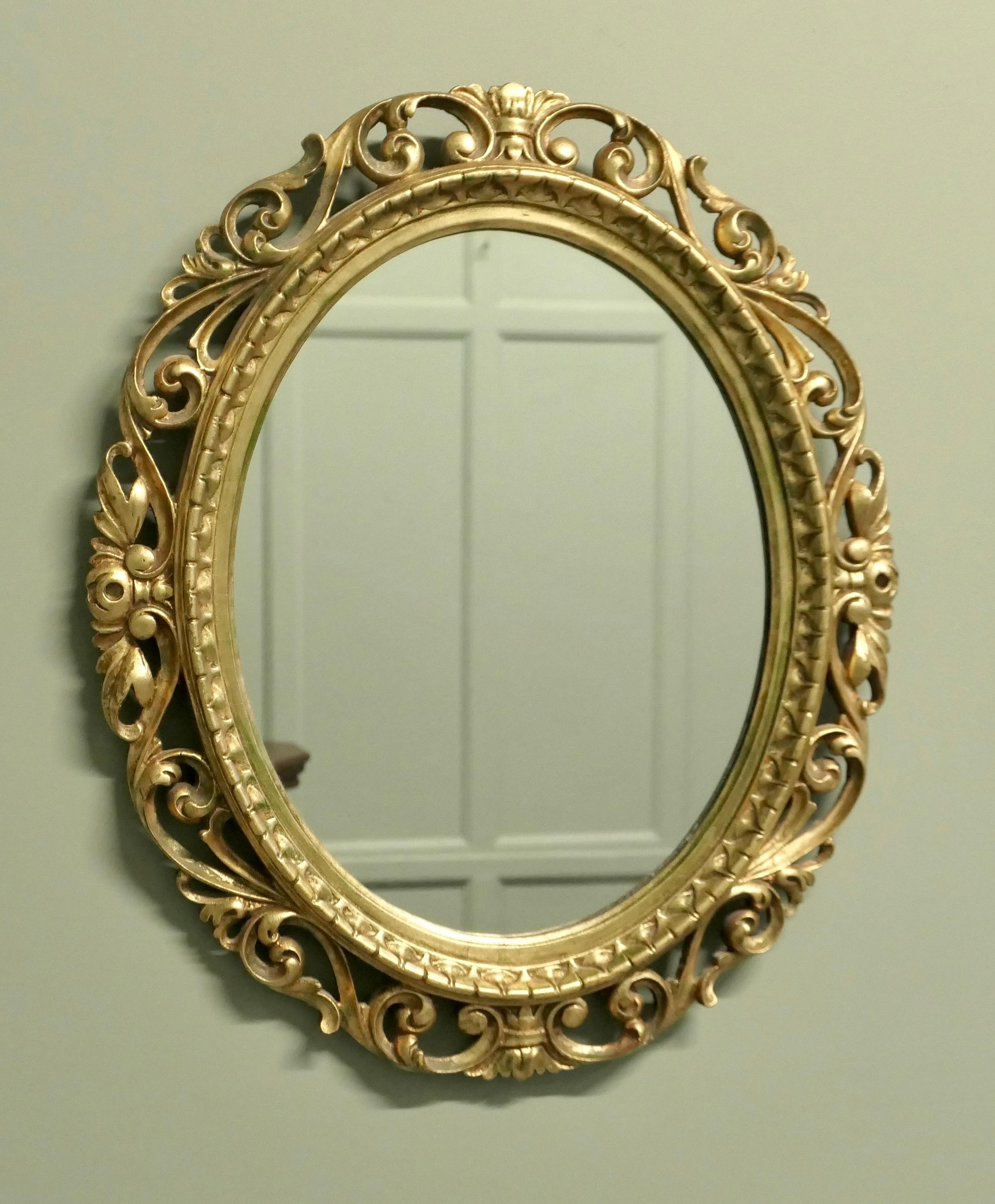 Large Italian Decorative Gilt Oval Mirror

This Mirror has a wide pierced oval frame, carved with acanthus leaves and it has a very good gilt finish
The Oval frame is in attractive condition as is the looking glass
The mirror is 21” wide and 25”