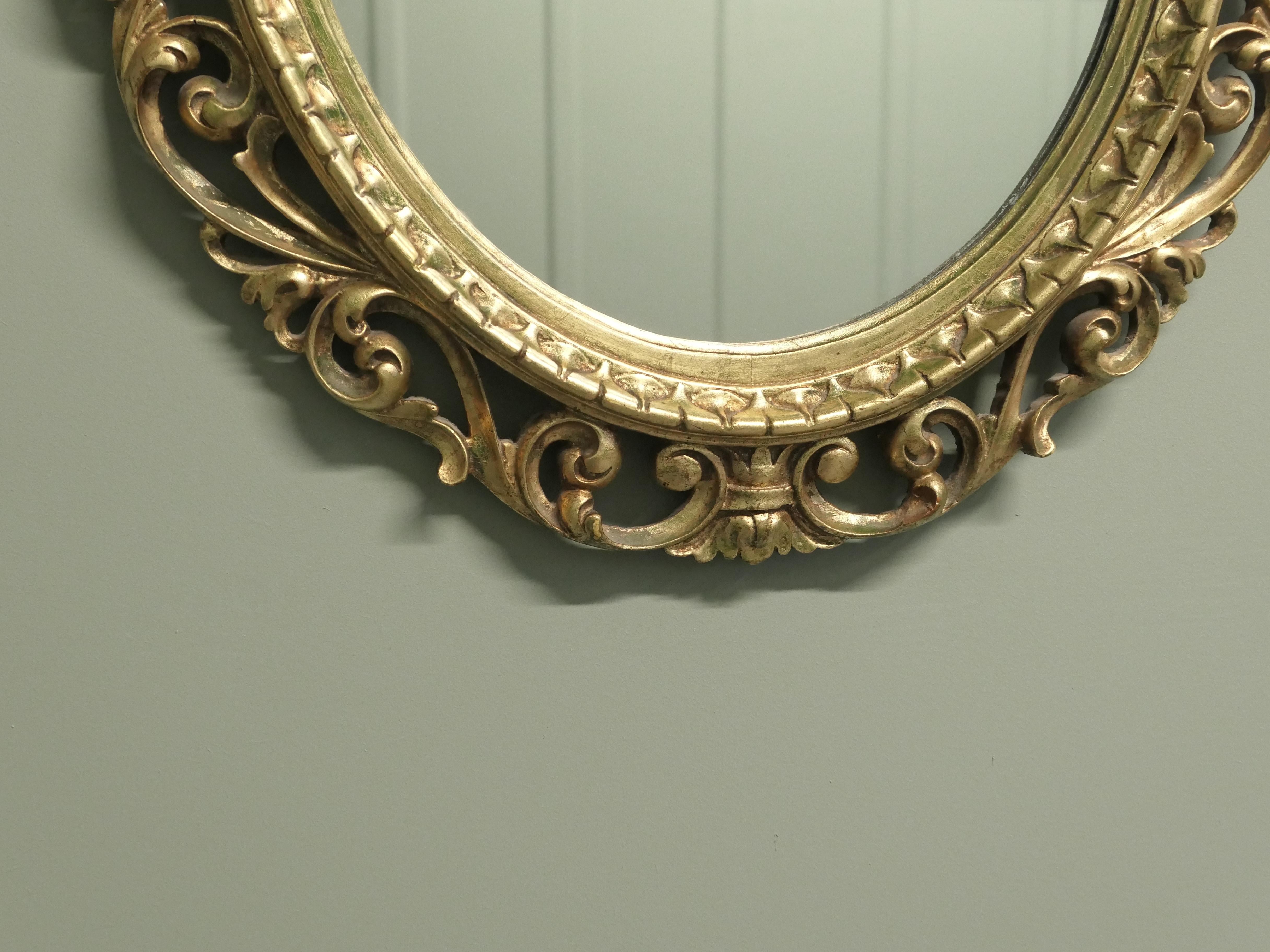 Large Italian Decorative Gilt Oval Mirror In Good Condition For Sale In Godshill, Isle of Wight