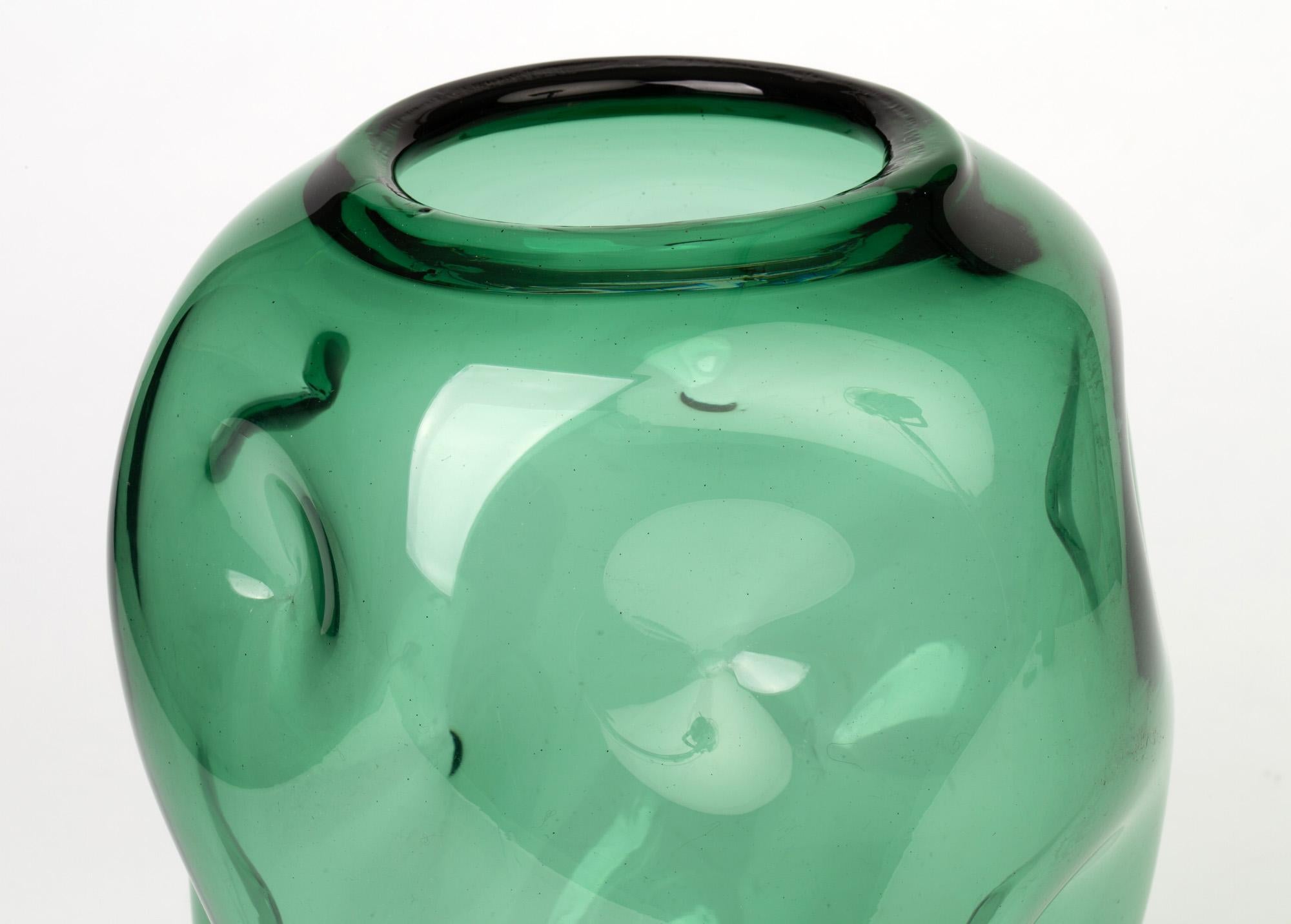 A stunning large midcentury hand blown green art glass vase with a dimple design, probably Italian and attributed to Empoli. The large bulbous shaped vase stands on a flat rounded foot with a partially polished pontil mark the body widening slightly