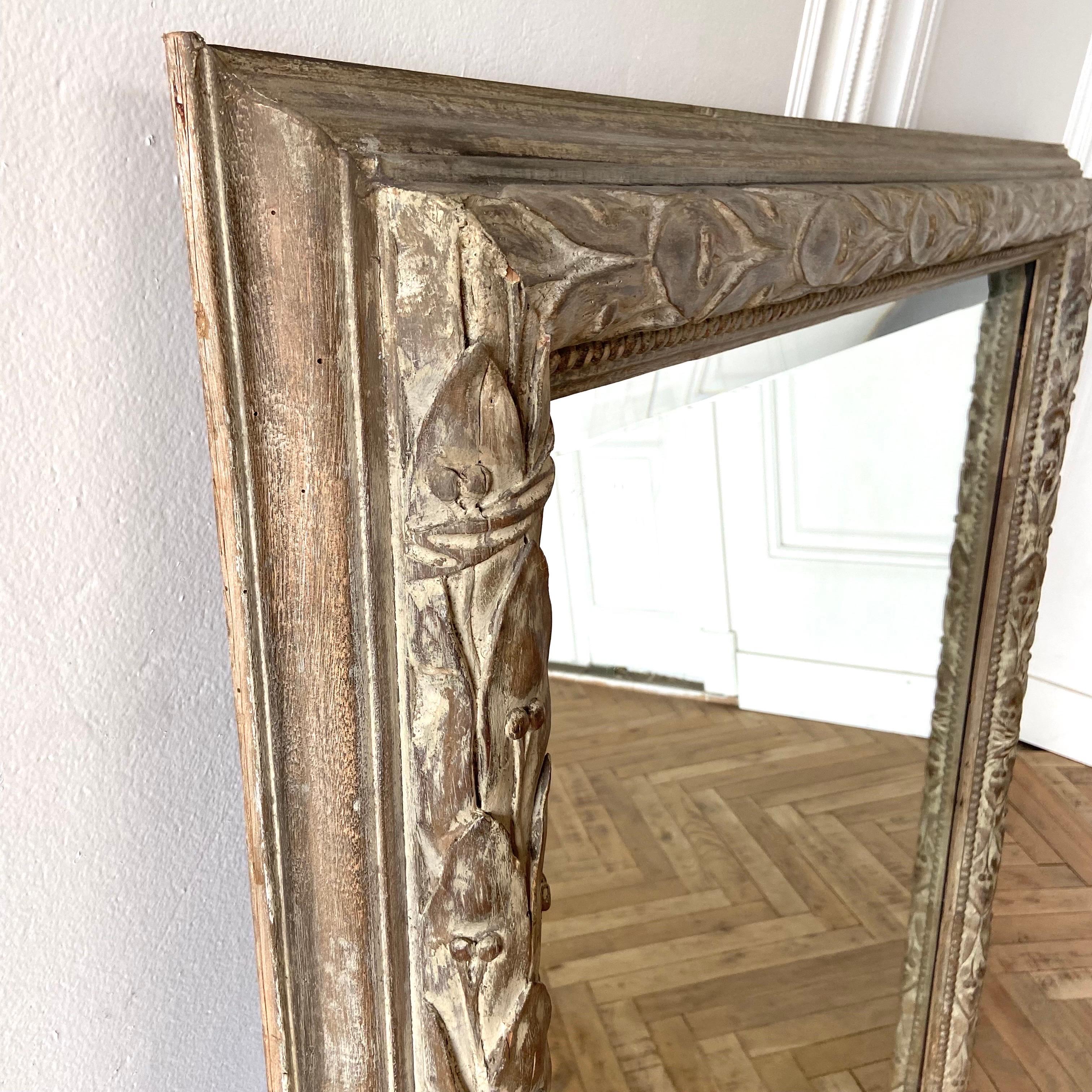 Vintage Italian gilt wood mirror that has a faded stripped finish.
Raw natural wood with remnants of bole and gilt leaving a natural raw patina.
Size of Mirror 52” width x 59” height and 3