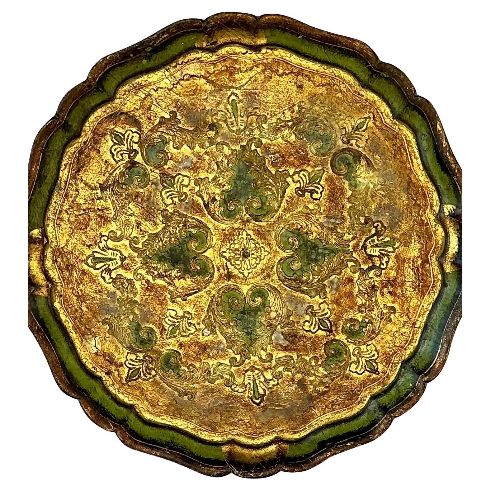 Large Italian Florentine Giltwood Serving Tray. Tray features a beautifully scalloped edge and a richly painted surface in green and gold. The tray displays an ornate raised foliate and scroll motif, highlighted with gold leaf for a luminous,