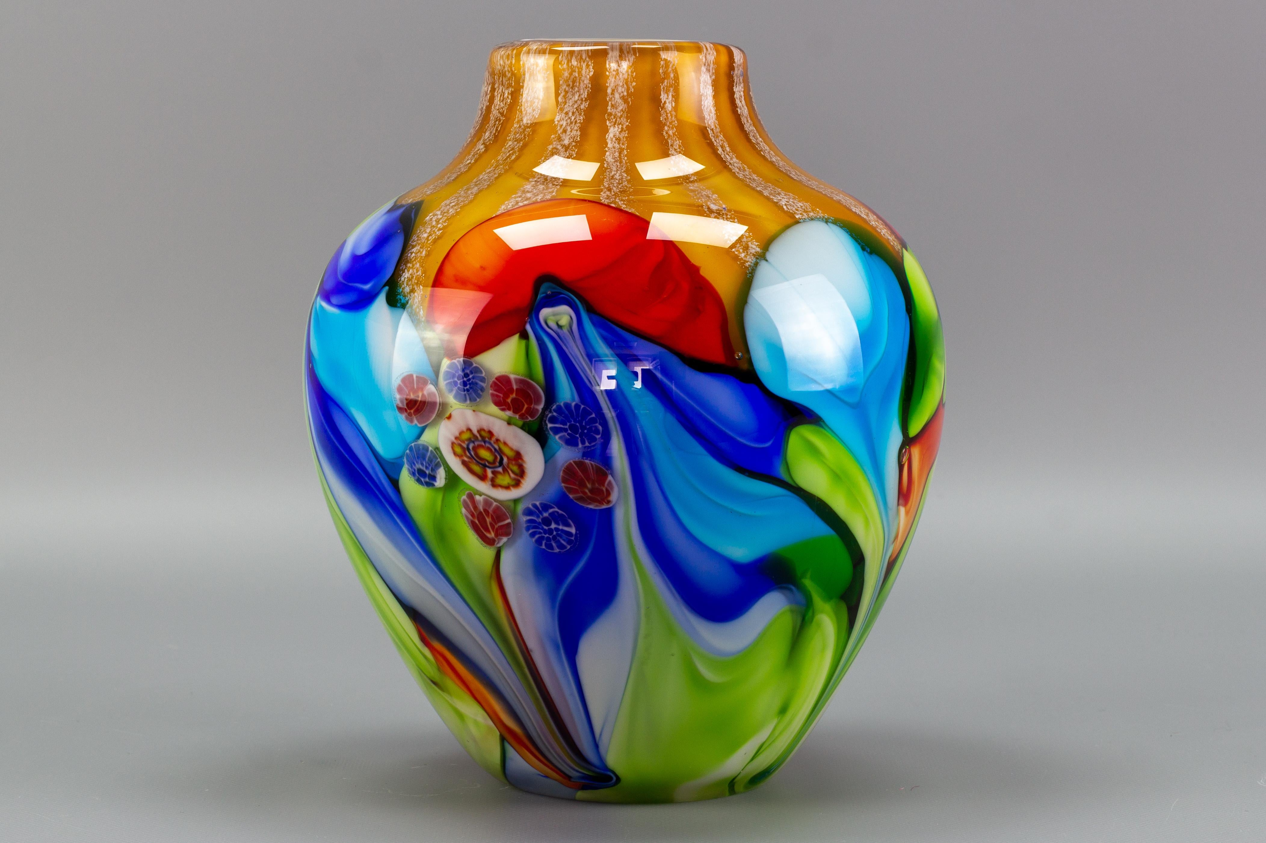 Absolutely gorgeous Murano glass convex vase with Millefiori flowers, attributed to Fratelli Toso. Beautiful and great array of colors - green, blue, red, white and amber, large and heavy vase.
Dimensions: height: 23.5 cm / 9.25 in; diameter: circa