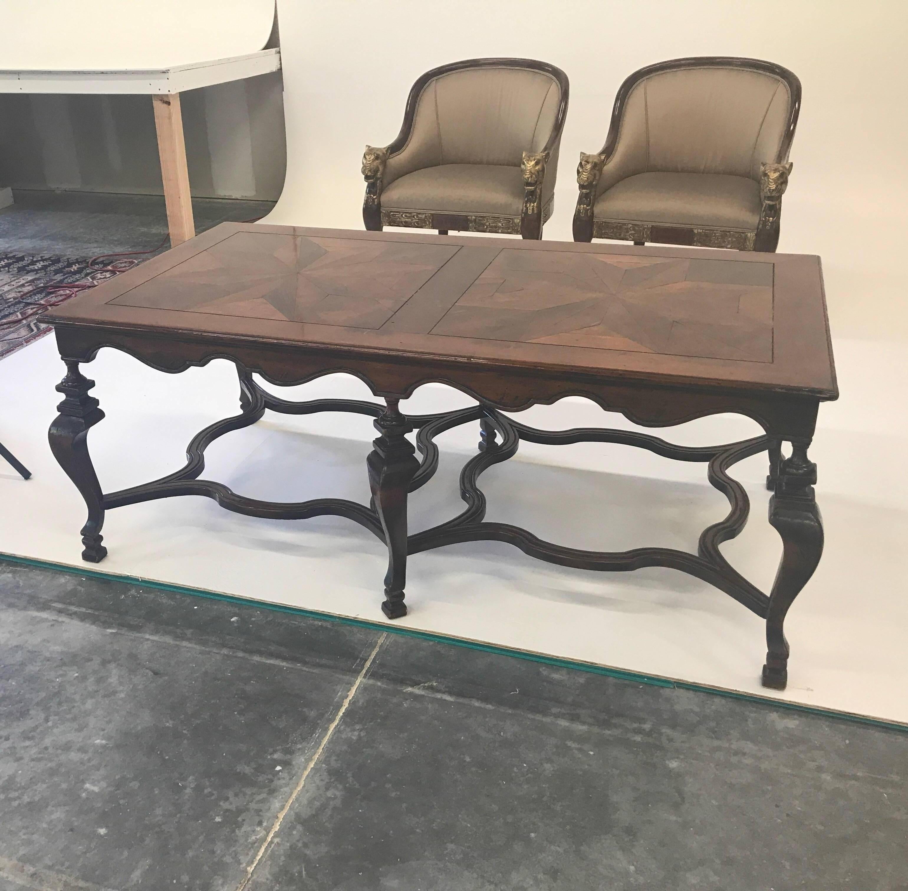 An rare and large fruitwood and walnut continental style cocktail table. This table is a full 62 inches long and taller than average 24 inches tall. The six graceful legs are supported by shapely stretchers for a sturdy surface. The top with a
