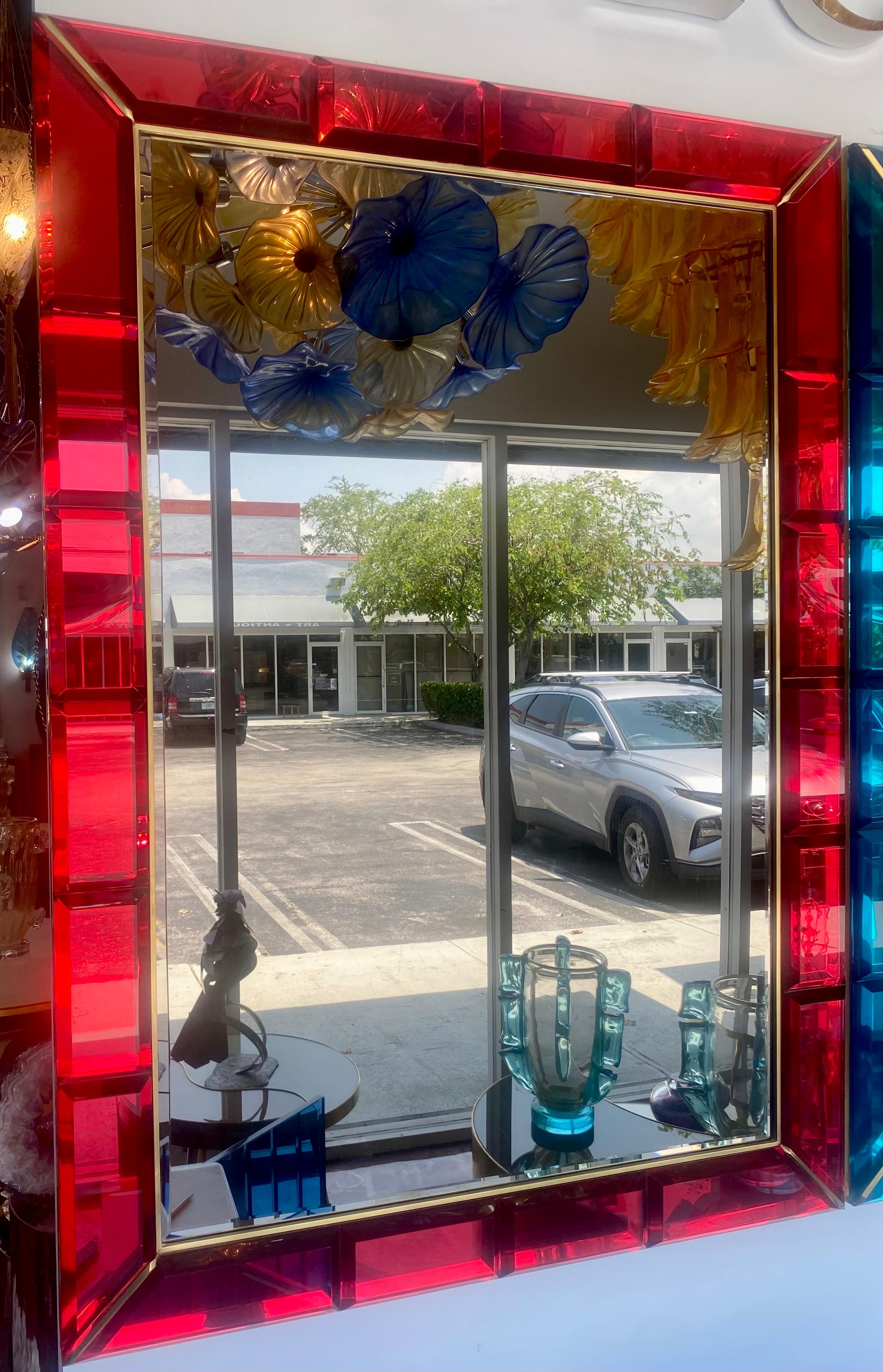 A beautiful Mid-Century Italian ruby red gem beveled lucite hand made lucite mirror with brass trim.