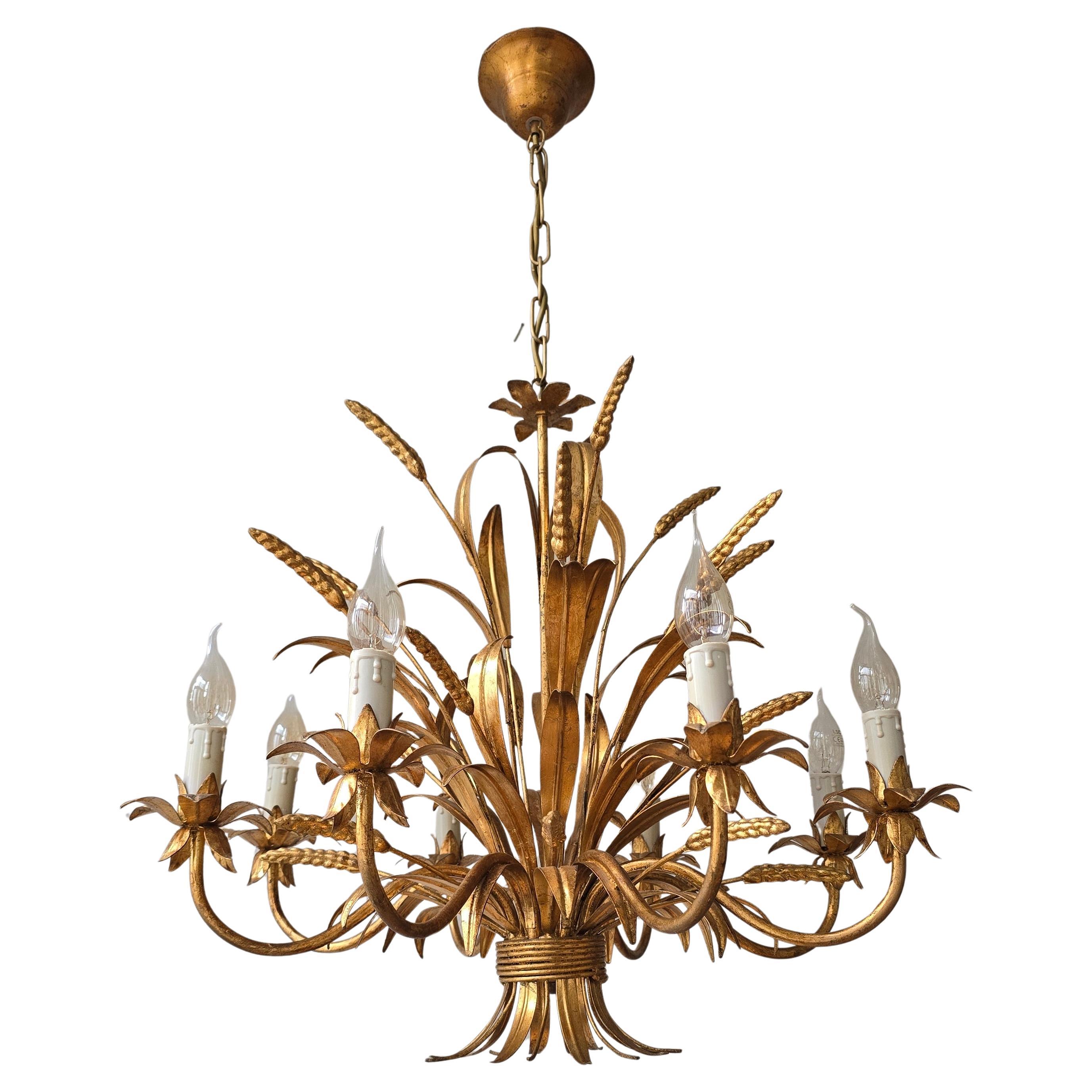 Florentine hand-gilded wheat sheaf chandelier with eight lights — three available

A beautifully detailed Italian chandelier in gilt tole, designed as a wheat sheaf bound at the center. With eight candle lights surrounded by gracefully curved leaves