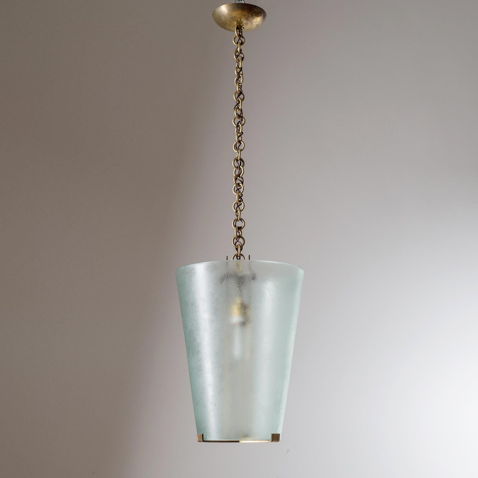 Fine modernist Italian glass lantern, circa 1960. The large conical glass diffuser - perched atop a Minimalist brass structure - is acid-treated on both sides, giving it a very coarse and irregular surface. One original brass and ceramic E27 socket