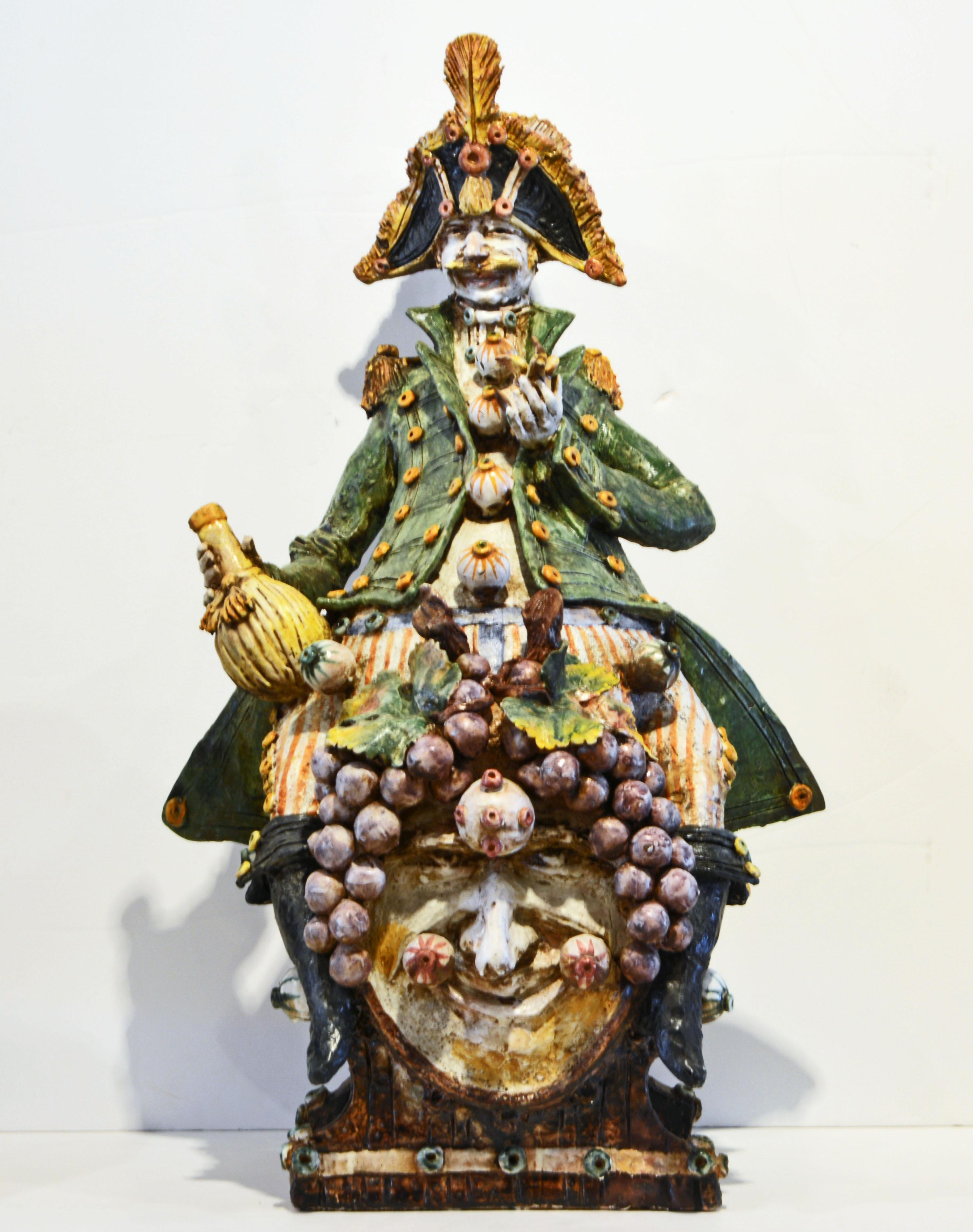 This whimsical Italian sculpture by Diego Poloniato demonstrates the artist's endless fantasy and imagination. Dressed in an 18th century uniform a likely general is sitting on a wine barrel holding a bottle of Chianti in his right hand and a little