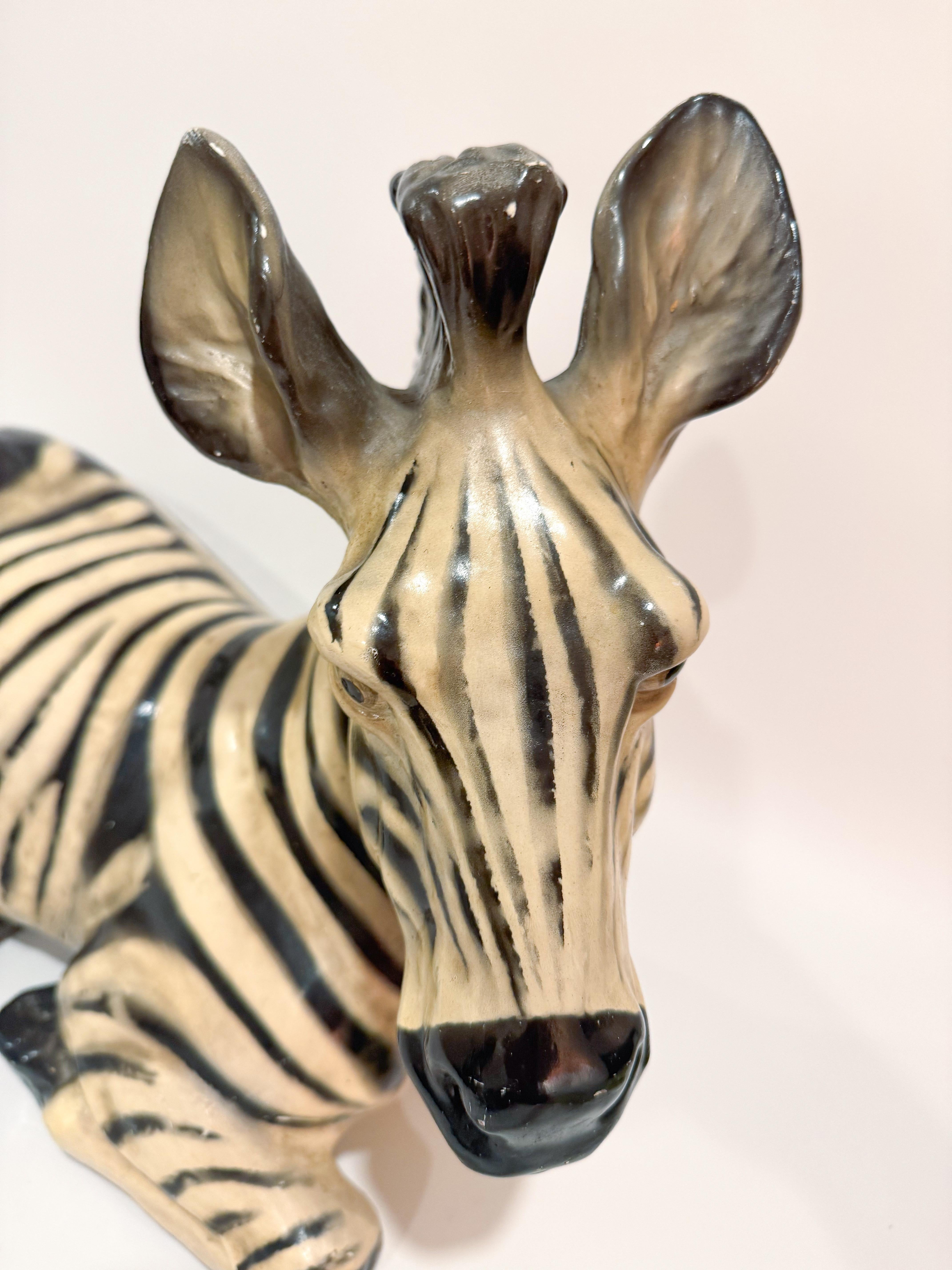 An exceptional and rare large Italian terracotta zebra sculpture, crafted in the 1960s and evocative of the bold and playful charm of mid-century Italian design. This vintage zebra statue is made from hand-molded terracotta, beautifully glazed in
